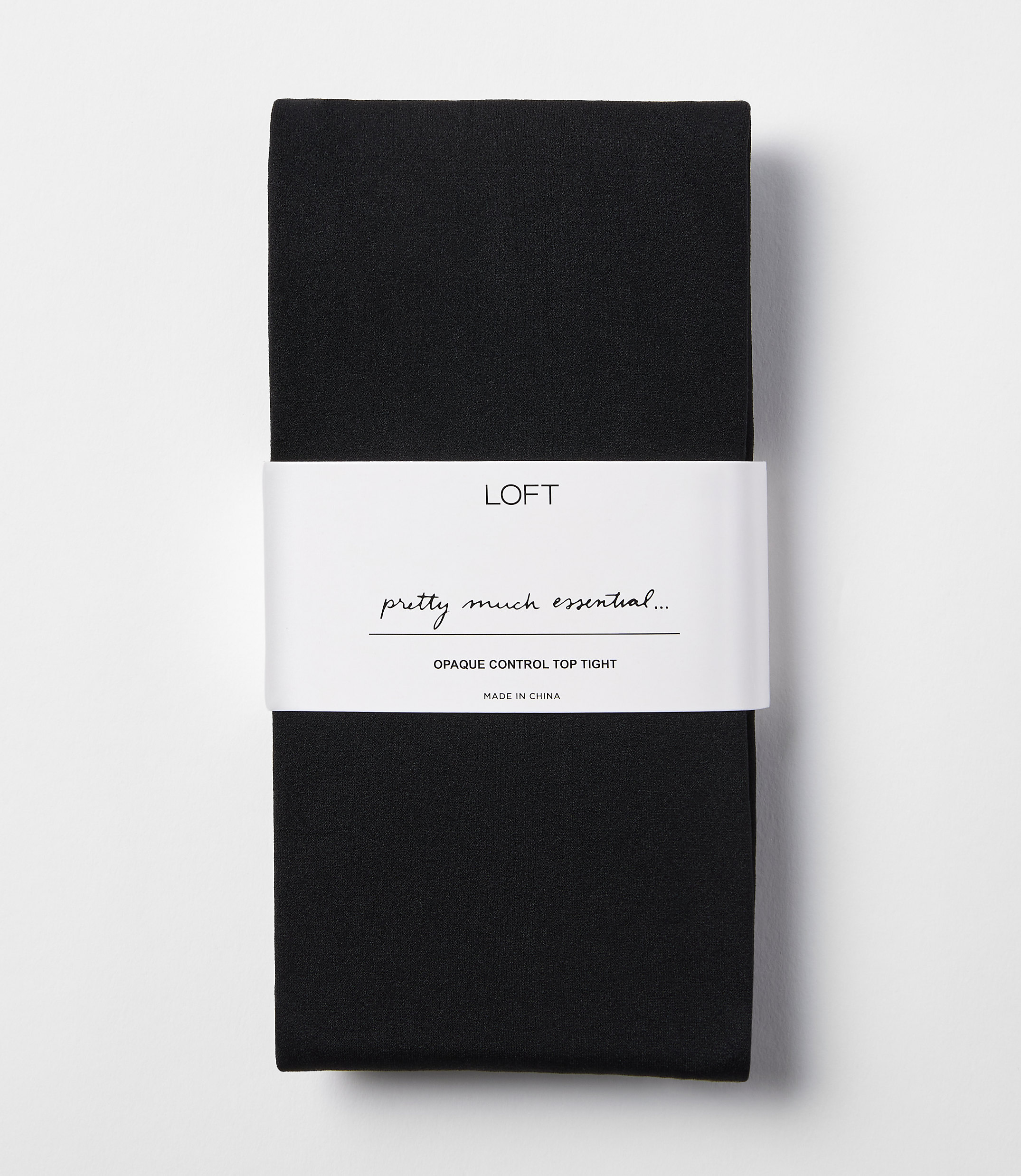 A pair of black opaque control top tights is neatly folded with a white band around the middle, set against a plain white background.