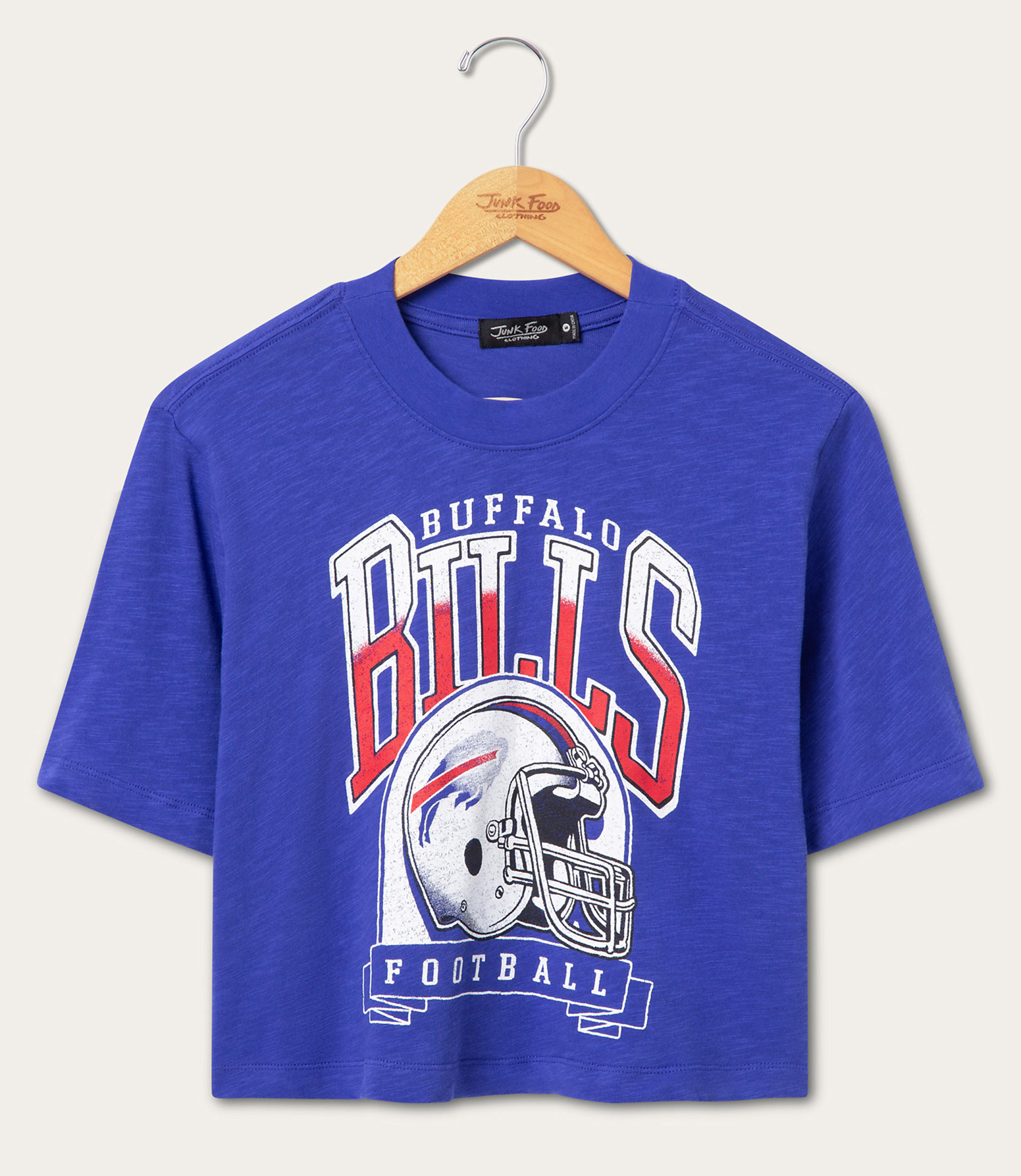 A royal blue cropped t-shirt with a vintage Buffalo Bills graphic hangs on a wooden hanger against a plain white background.