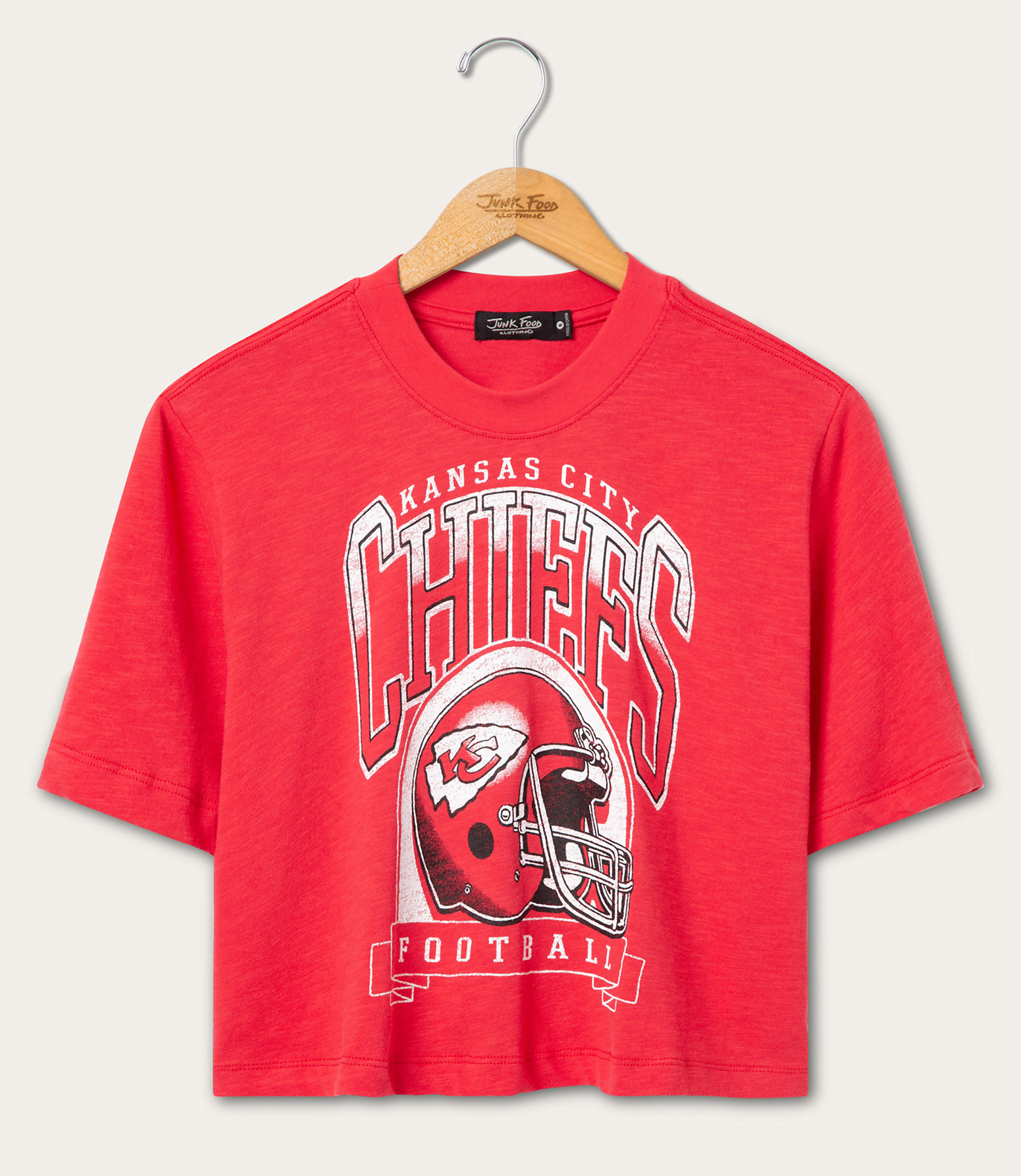 A red Kansas City Chiefs football t-shirt hangs on a wooden hanger against a plain white background.