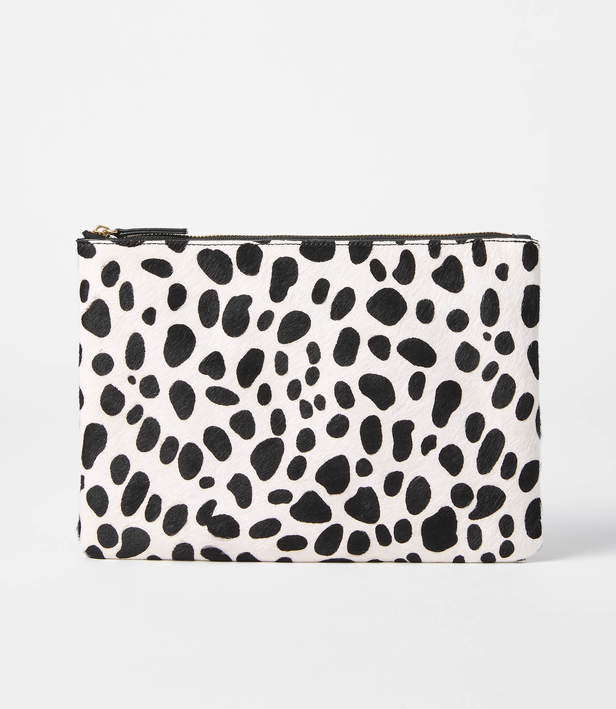 A black and white spotted clutch rests on a plain white background.