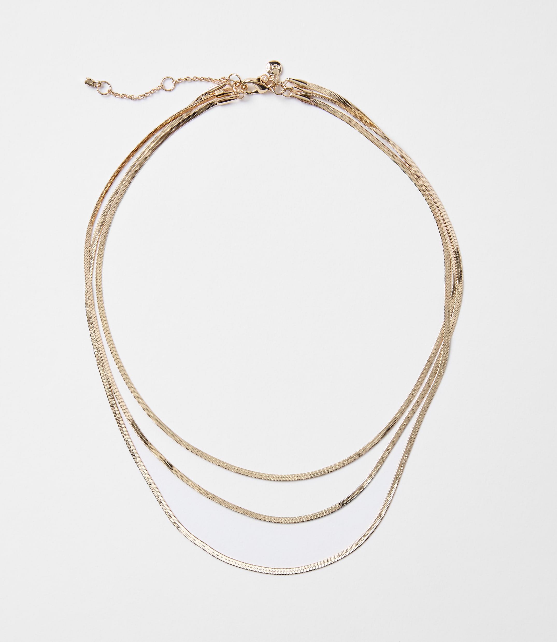 A delicate rose gold layered necklace with a white background.