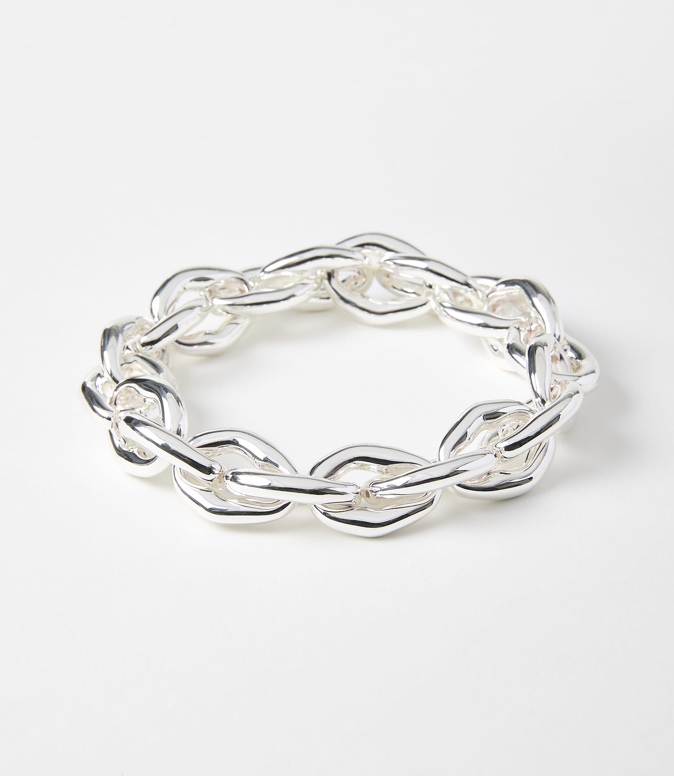 A chunky silver chain bracelet lies on a plain white background.