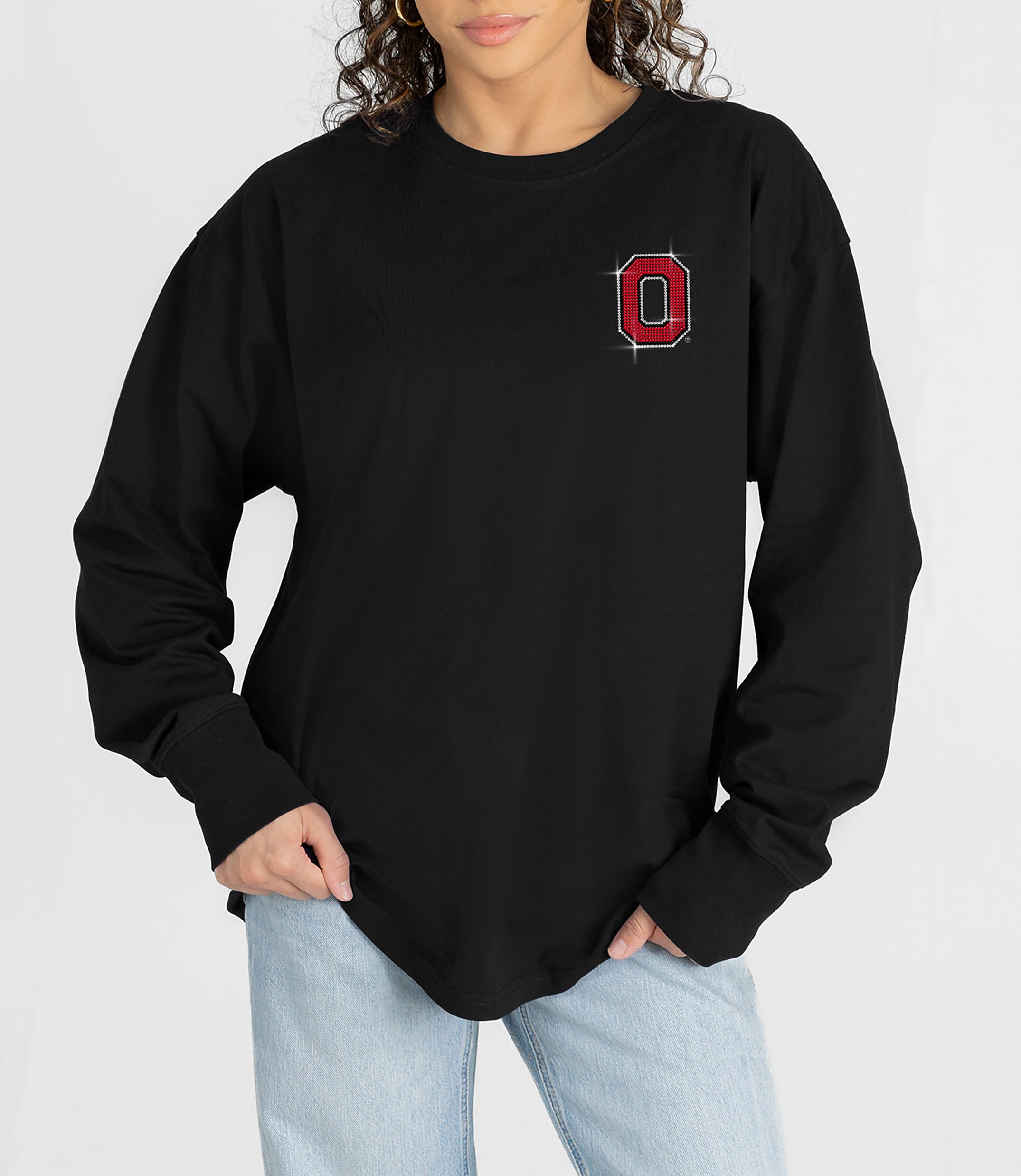A person in a black long-sleeved shirt with a red "O" emblem on the chest stands against a plain white background.