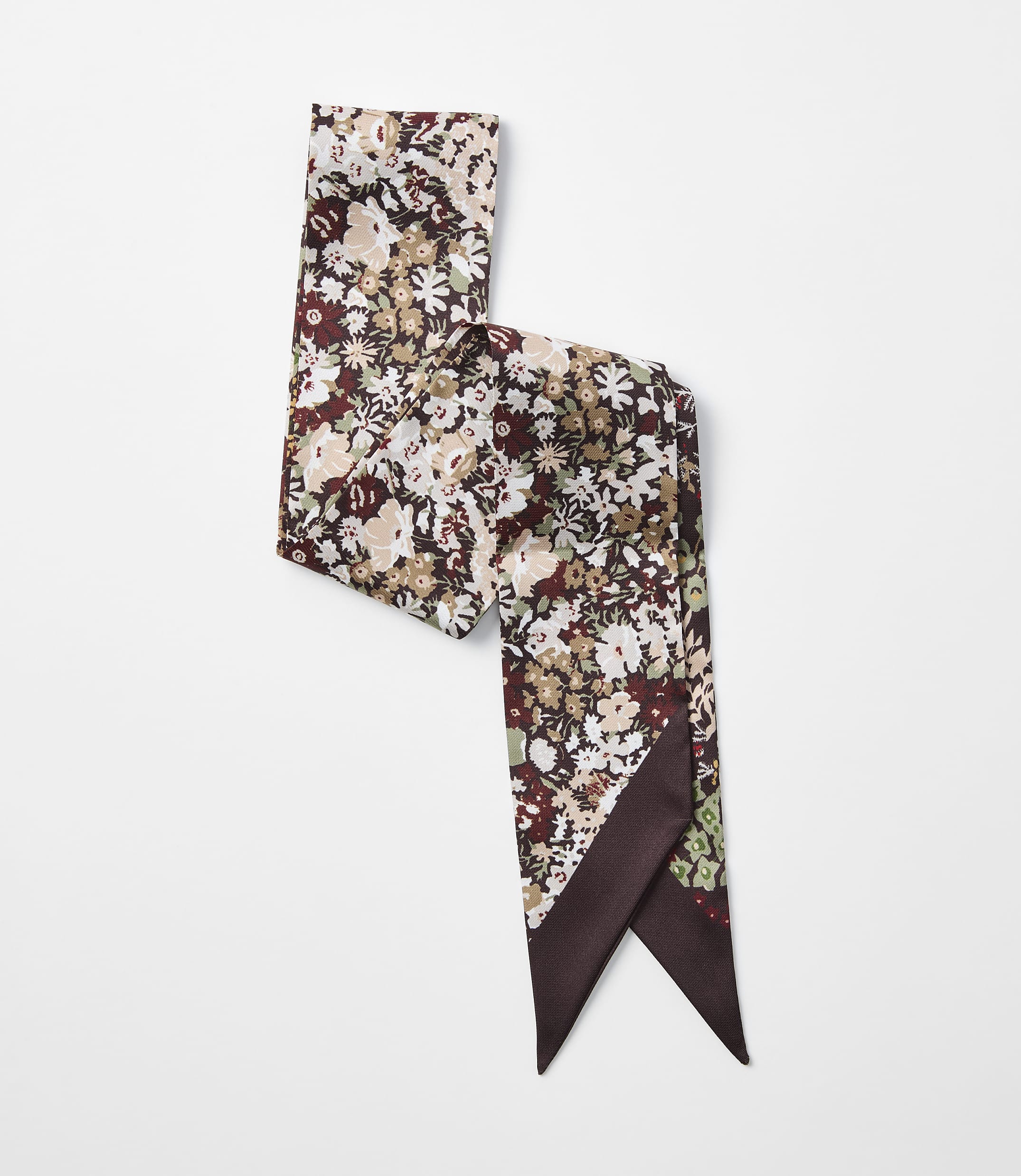 A floral patterned scarf with a dark brown border is laid out on a plain white background.