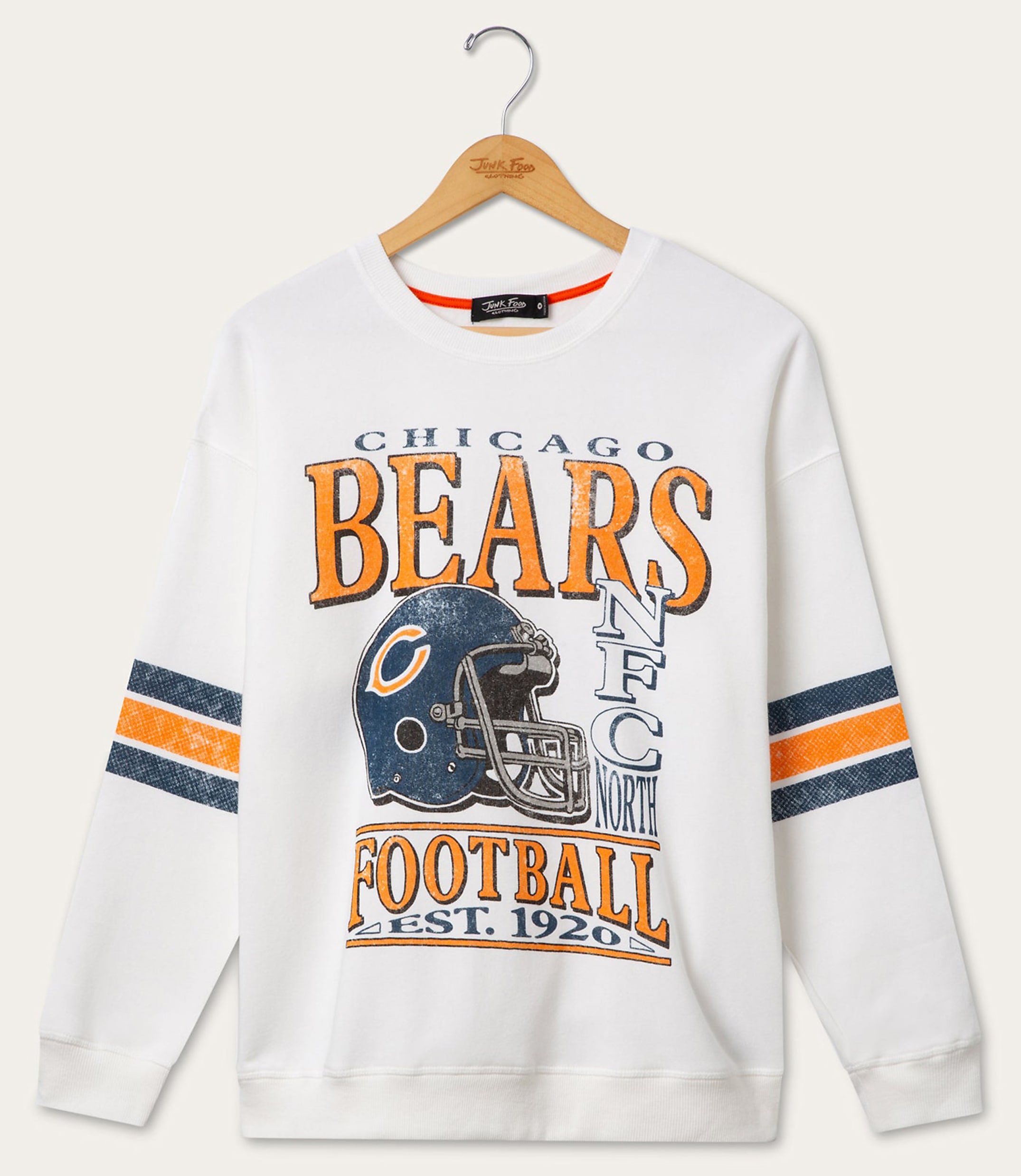 A white Chicago Bears sweatshirt with striped sleeves hangs on a wooden hanger against a plain white background.