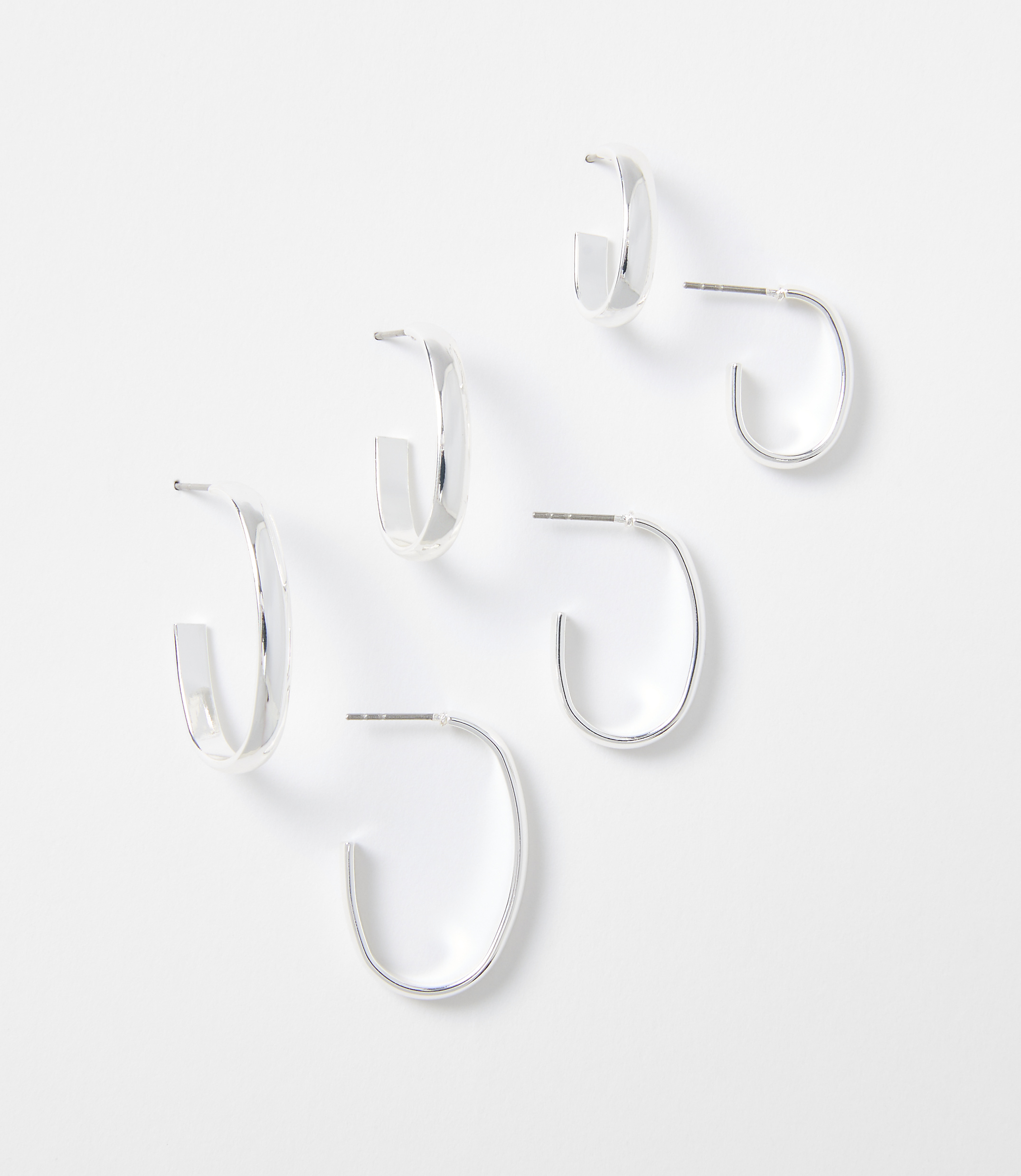 Three pairs of silver hoop earrings are arranged on a plain white background.