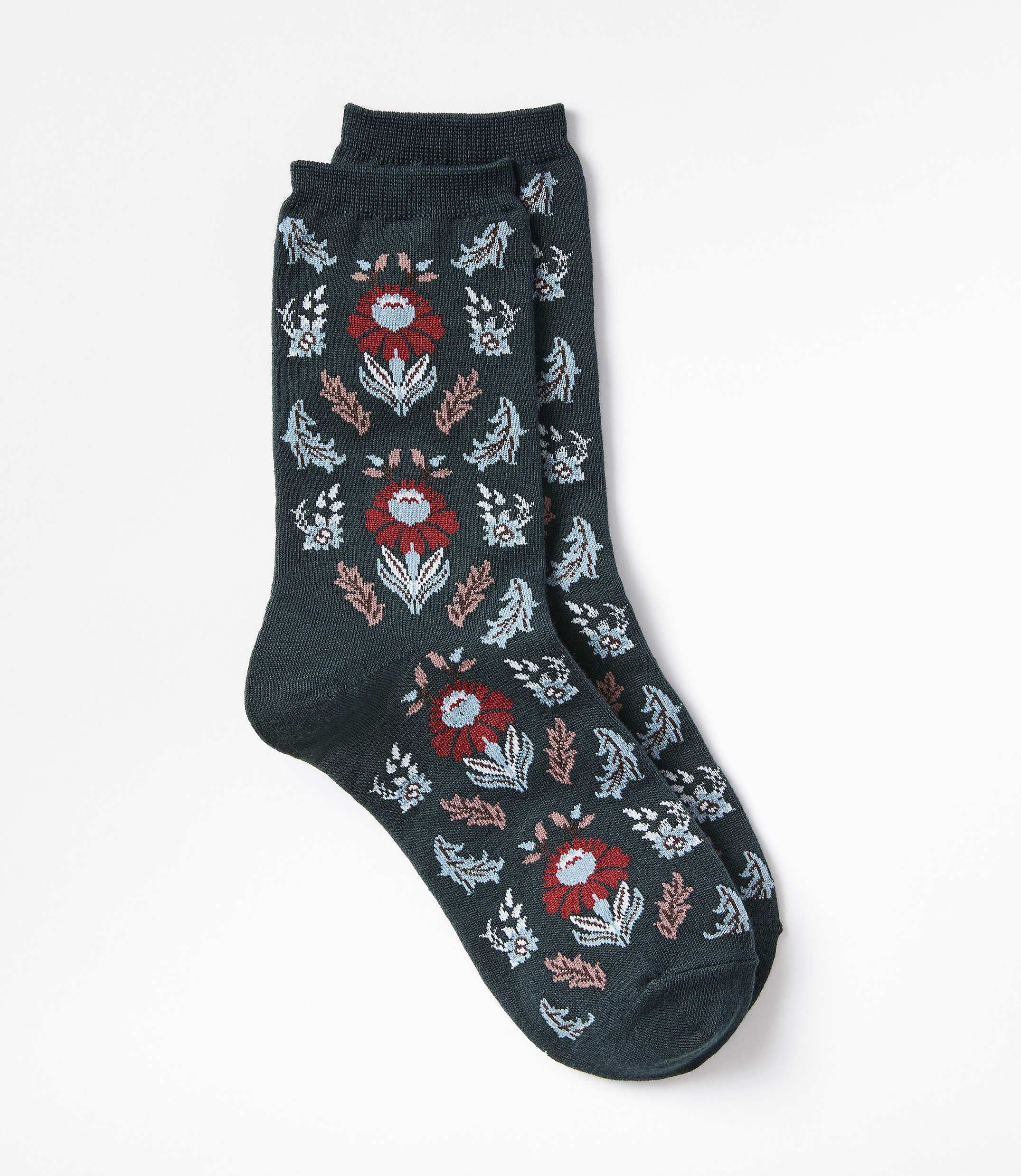 A pair of dark green socks with a floral pattern are laid out against a plain white background.