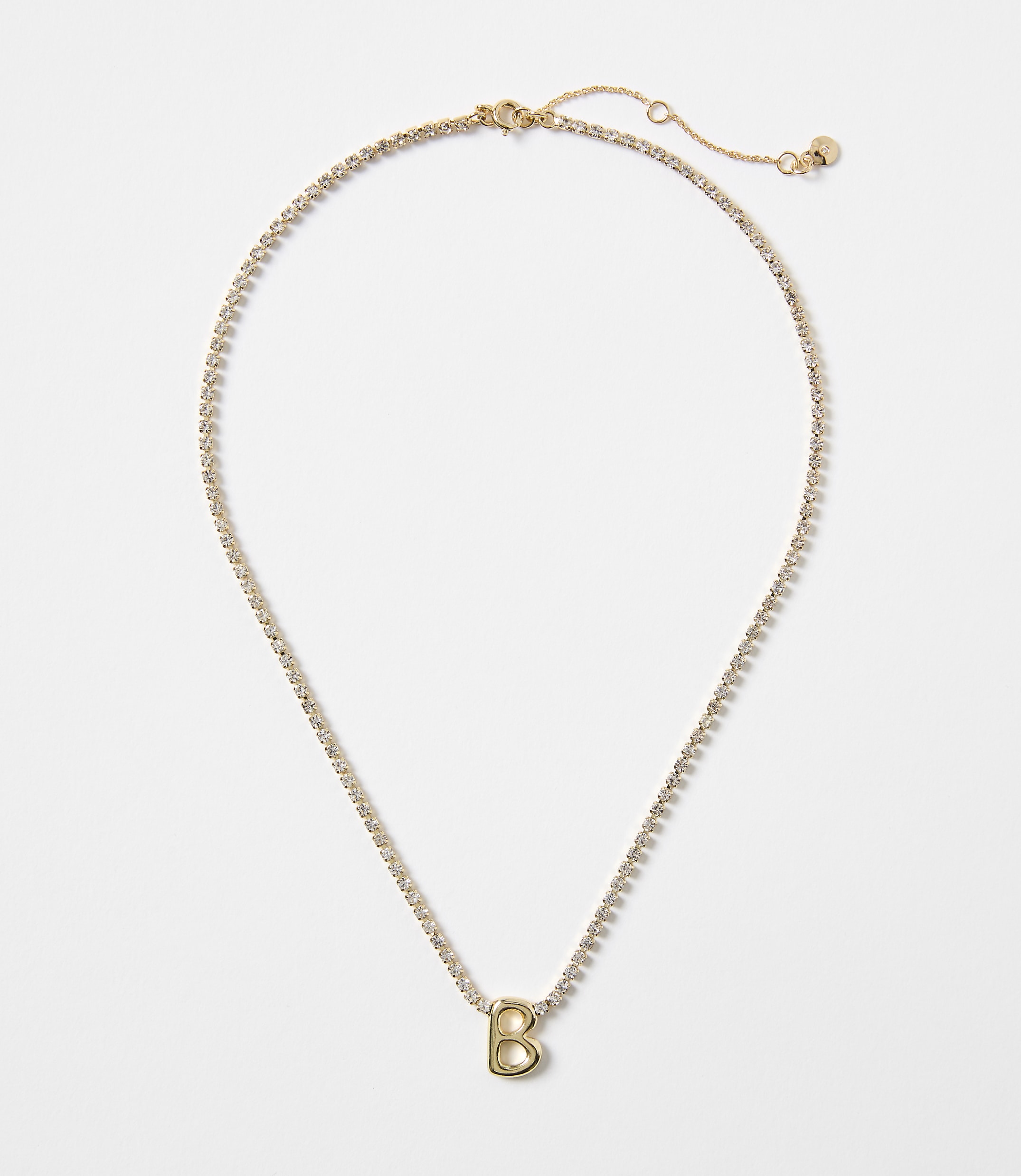 A gold necklace with a "B" charm and a white background.