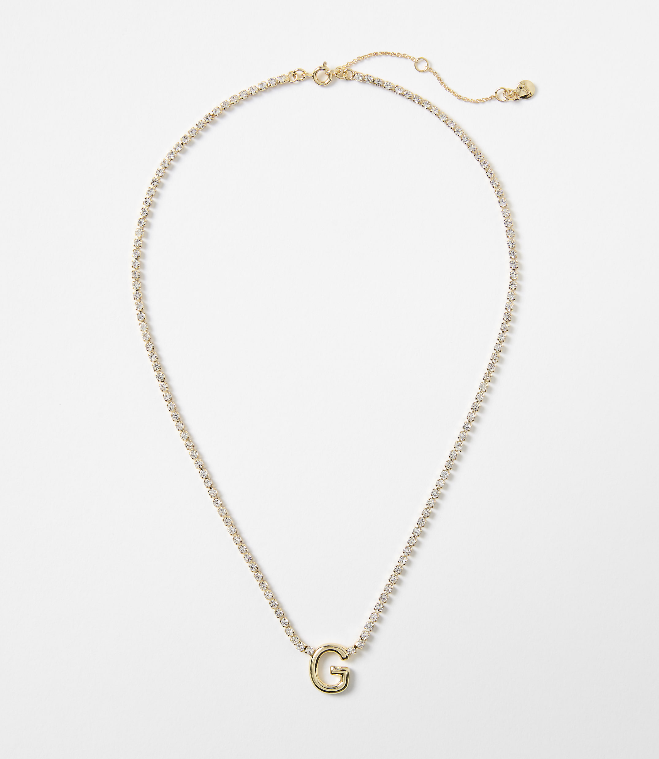 A gold necklace with a "G" pendant is displayed against a plain white background.