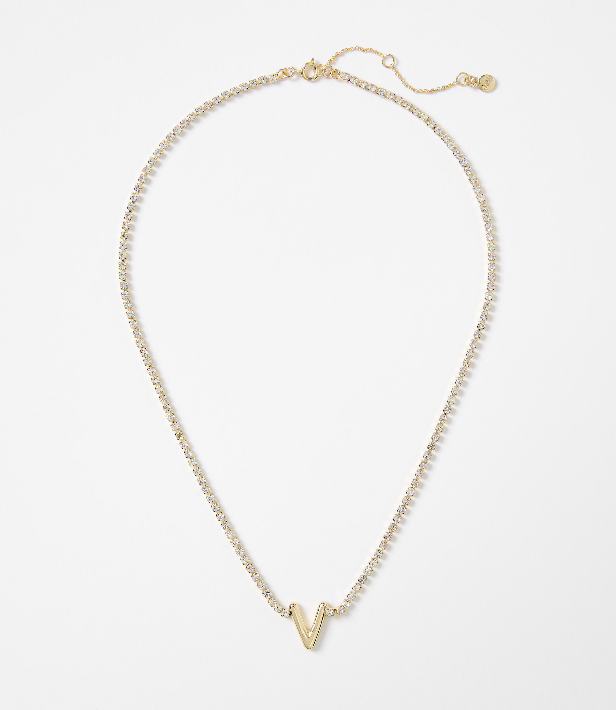 A gold necklace with a "V" pendant rests on a plain white background.