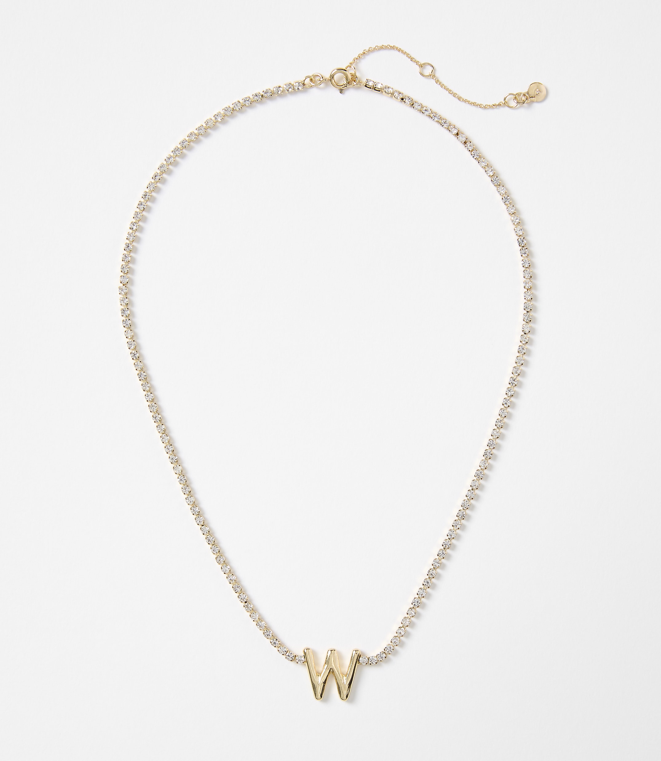 A gold letter "W" pendant is centered on a delicate, diamond-encrusted chain against a plain white background.