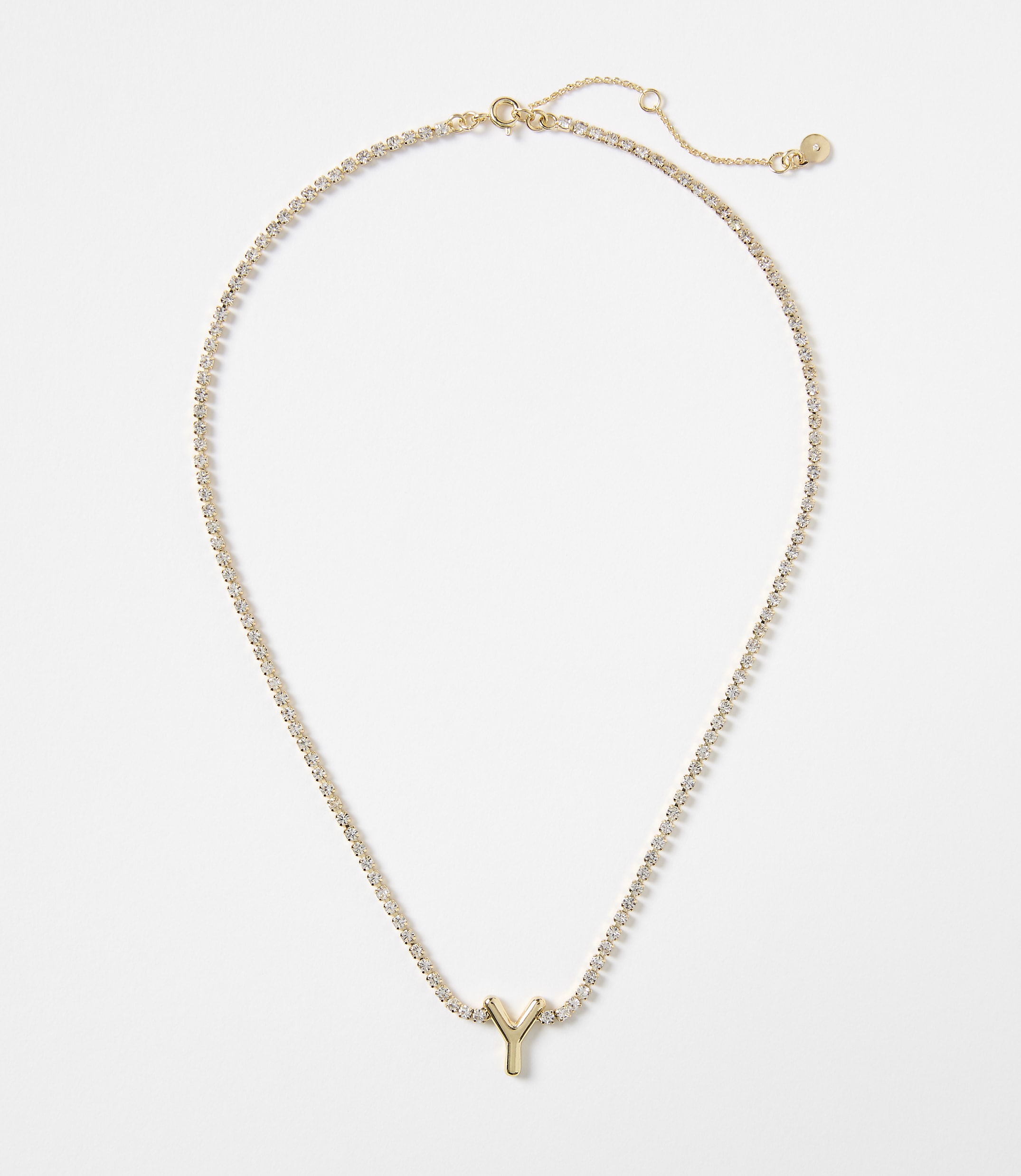 A gold letter "Y" pendant hangs from a delicate, sparkling chain against a plain white background.