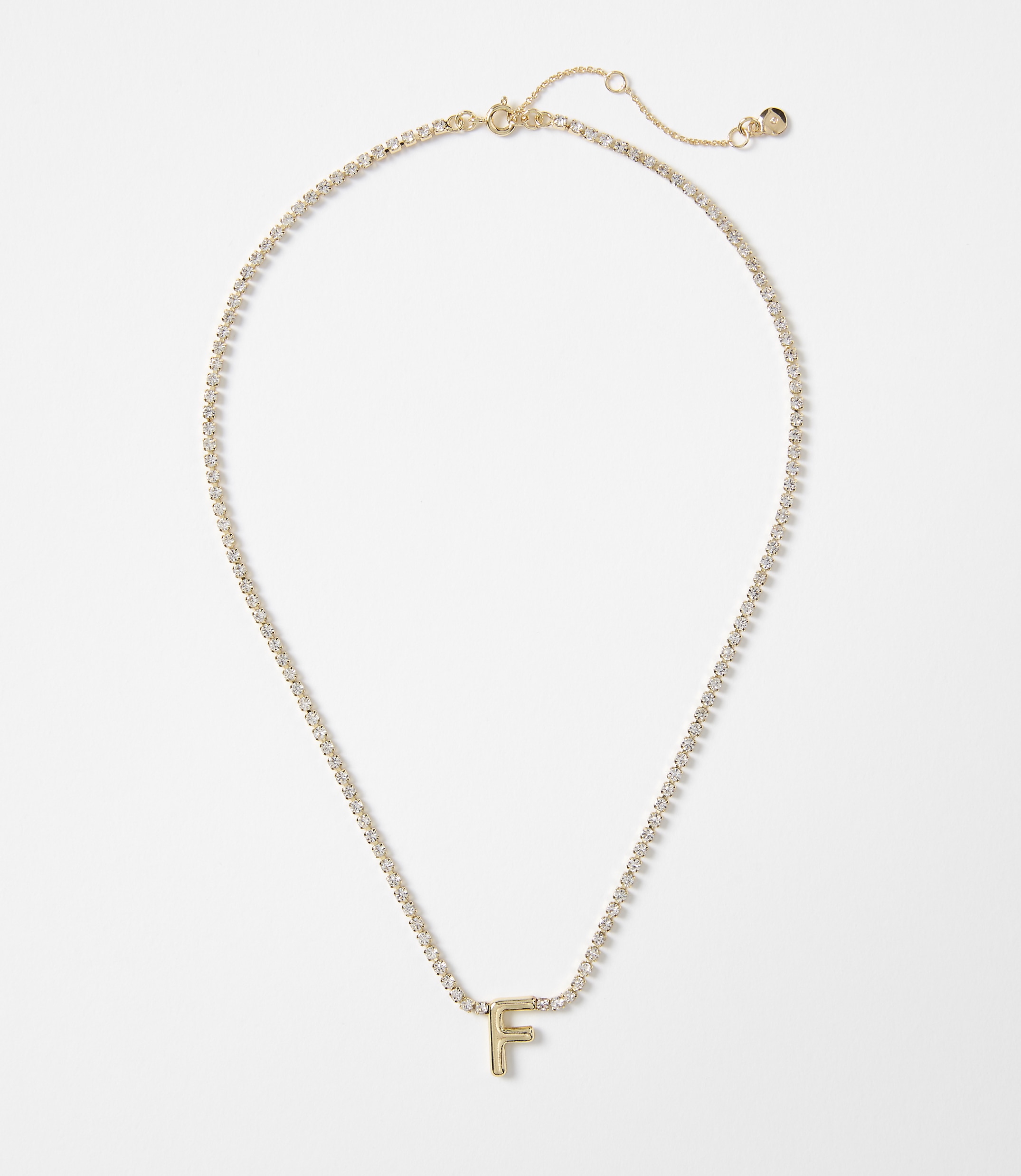 A gold letter "F" pendant hangs from a delicate, diamond-encrusted chain against a plain white background.