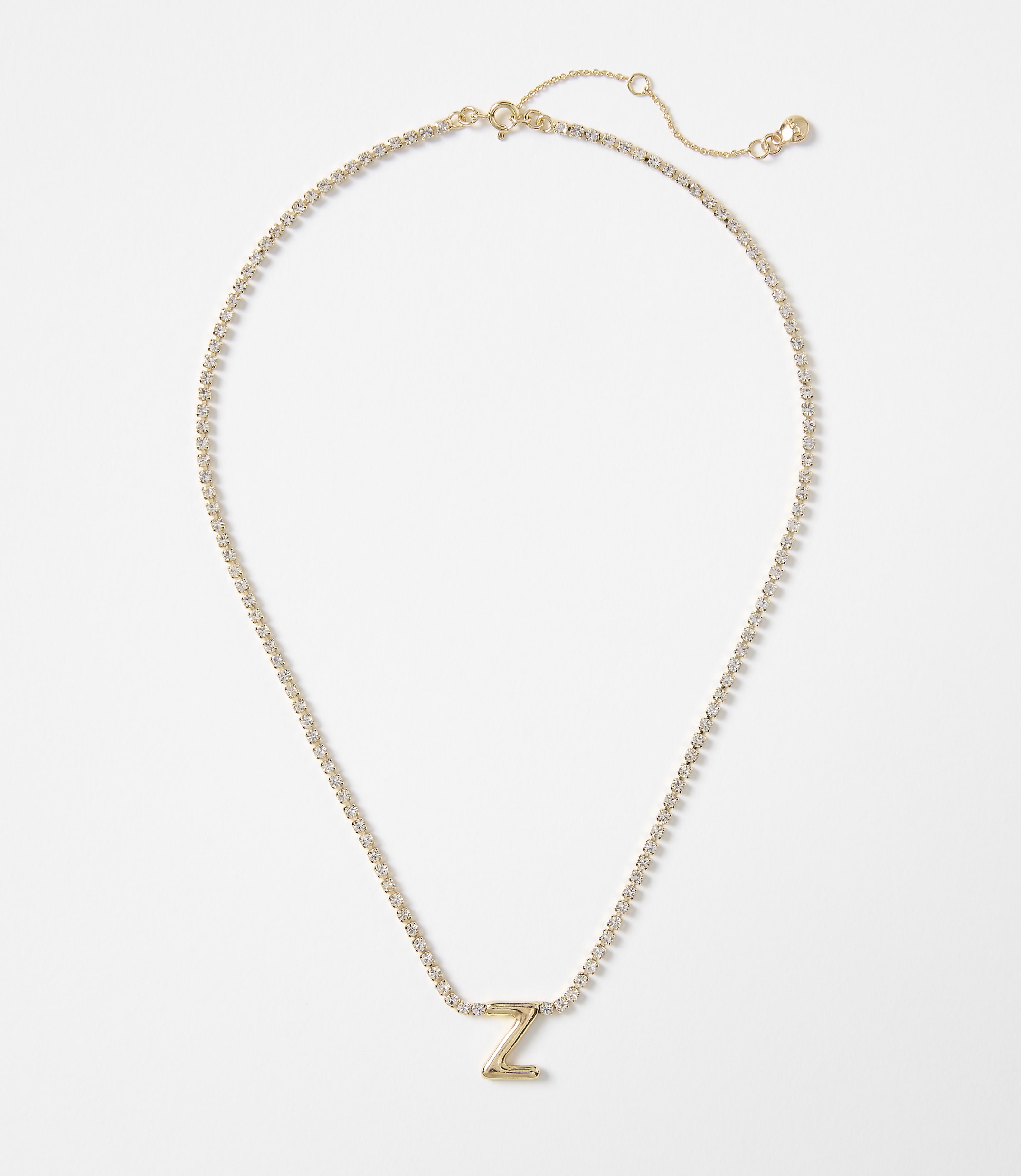 A gold letter "Z" pendant necklace with a delicate chain rests on a plain white background.
