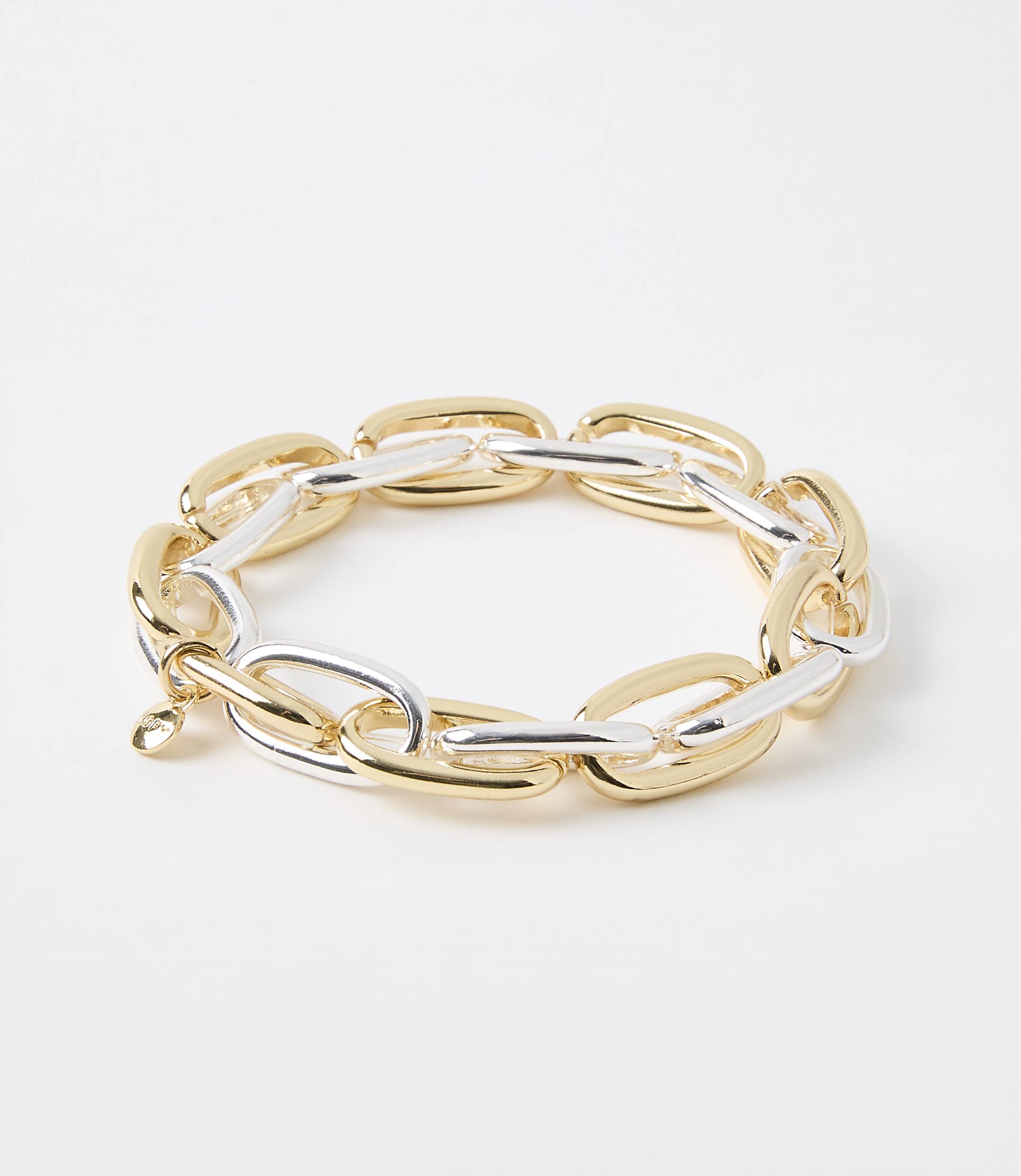 A chunky, two-toned gold and silver link bracelet rests on a plain white background.