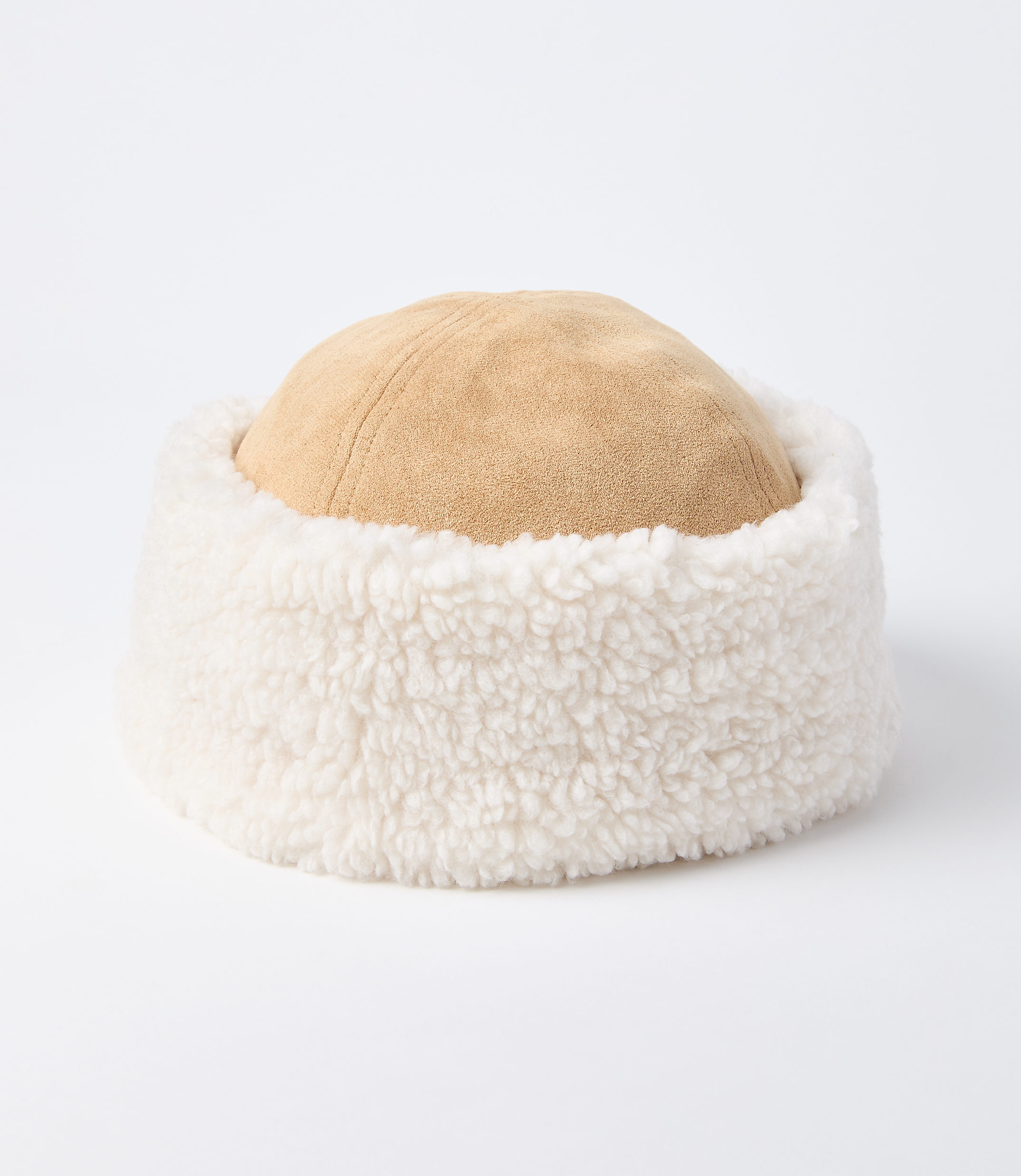 A tan suede hat with a fluffy white trim sits on a plain white background.