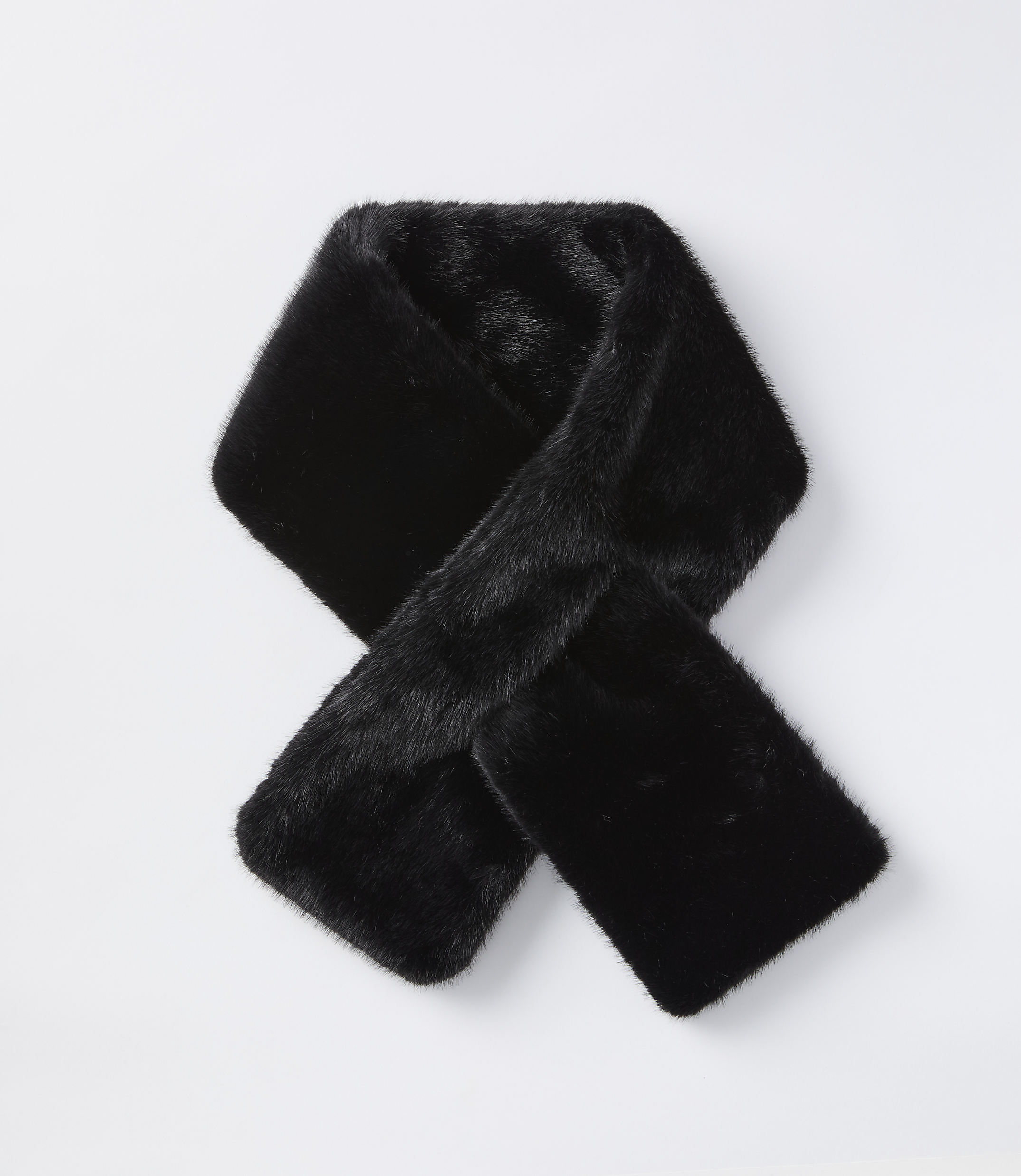A black faux fur scarf is laid out in a knot on a plain white background.