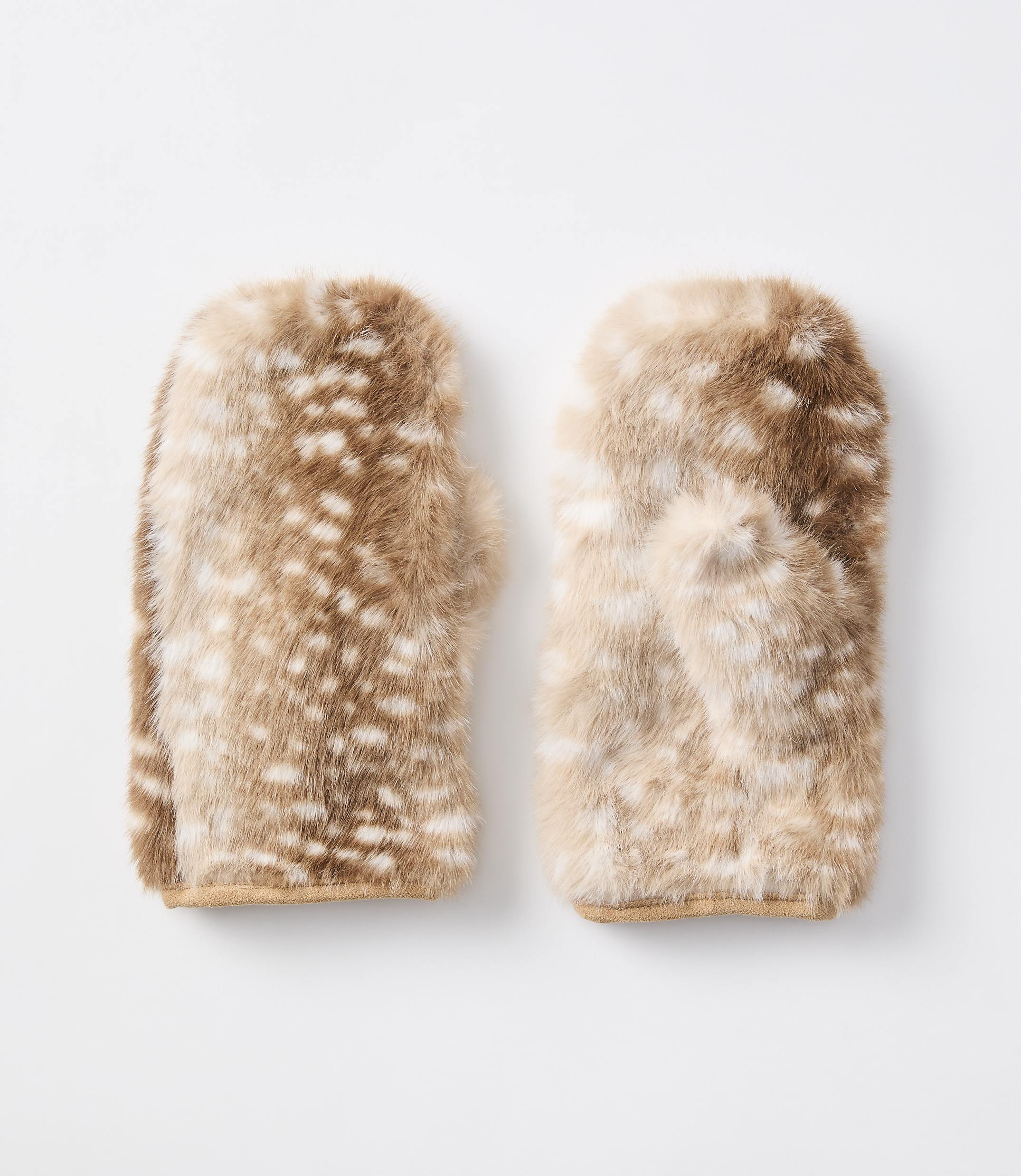 A pair of fuzzy, spotted mittens rests on a plain white background.