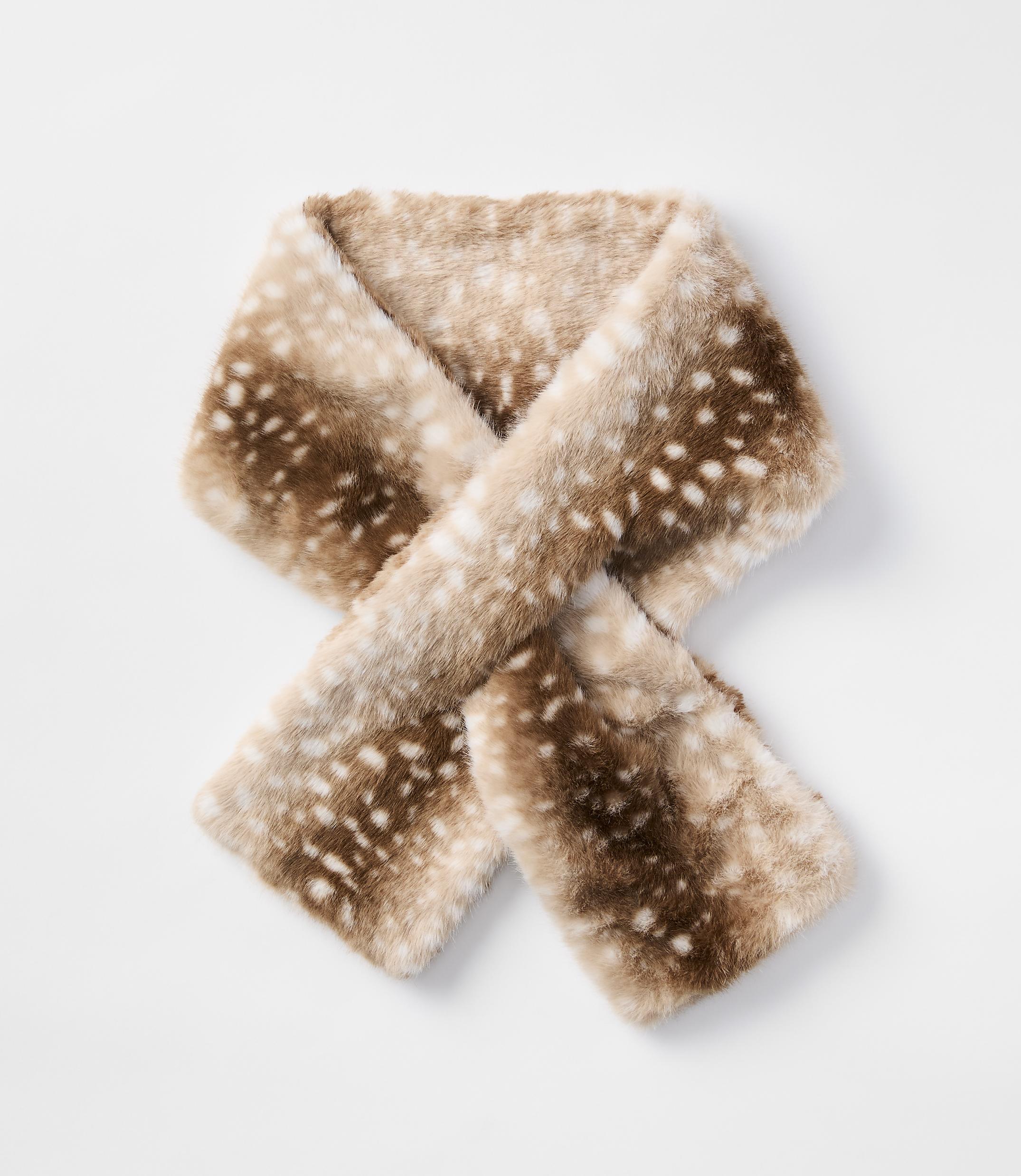 A fuzzy, fawn-spotted scarf is laid out against a plain white background.