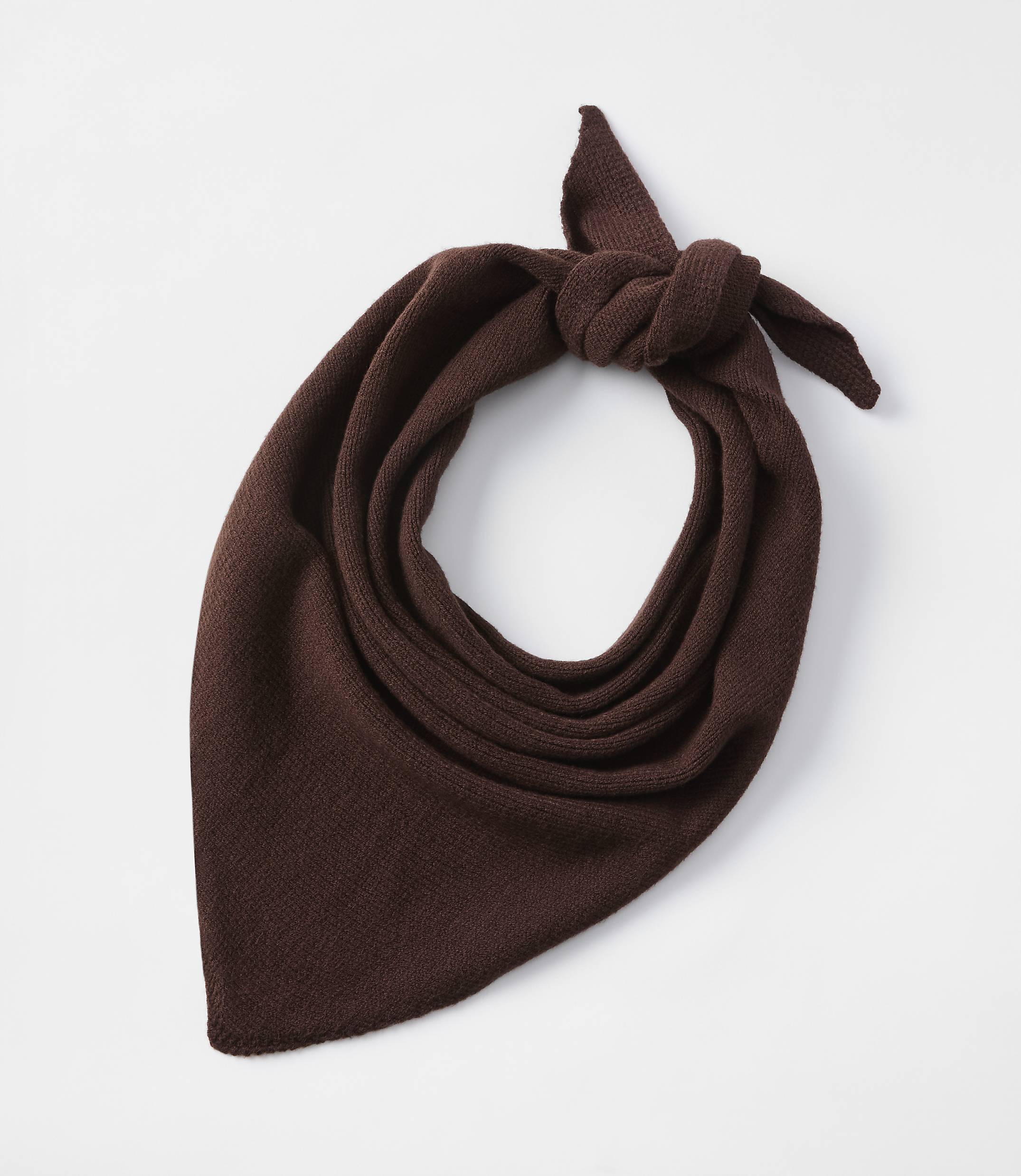 A brown knitted bandana is tied in a knot against a plain white background.