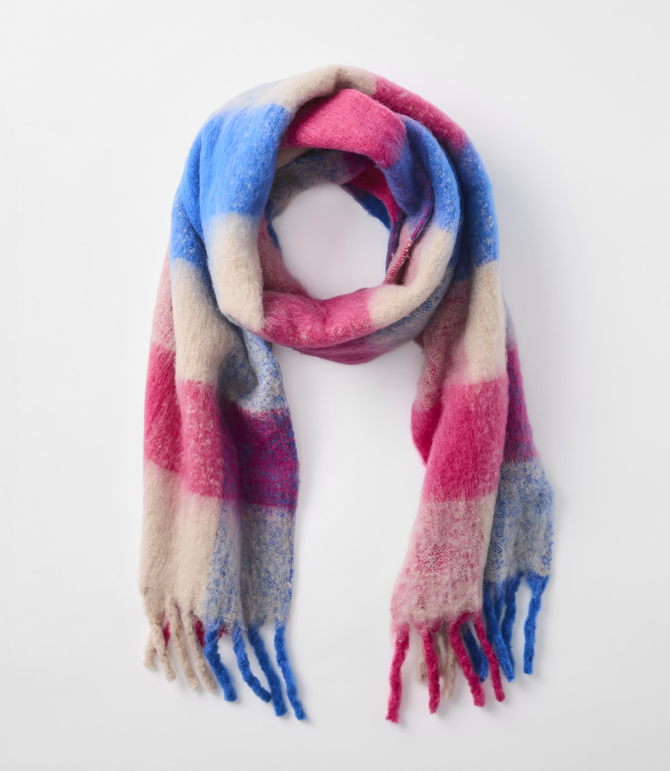 A colorful, plaid scarf with fringed ends is laid out against a plain white background.