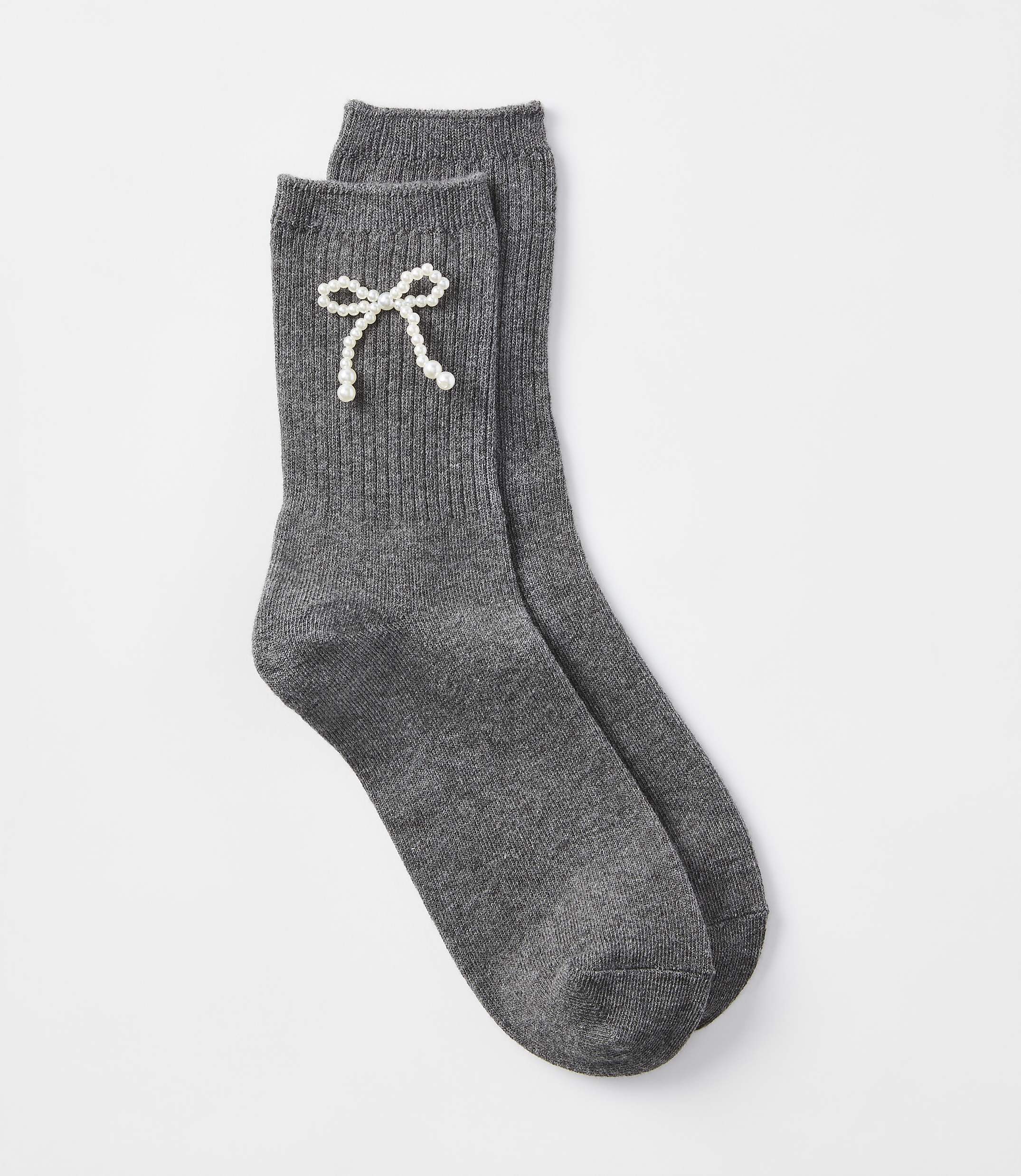 A pair of dark gray ribbed socks with a pearl bow detail rests on a plain white background.