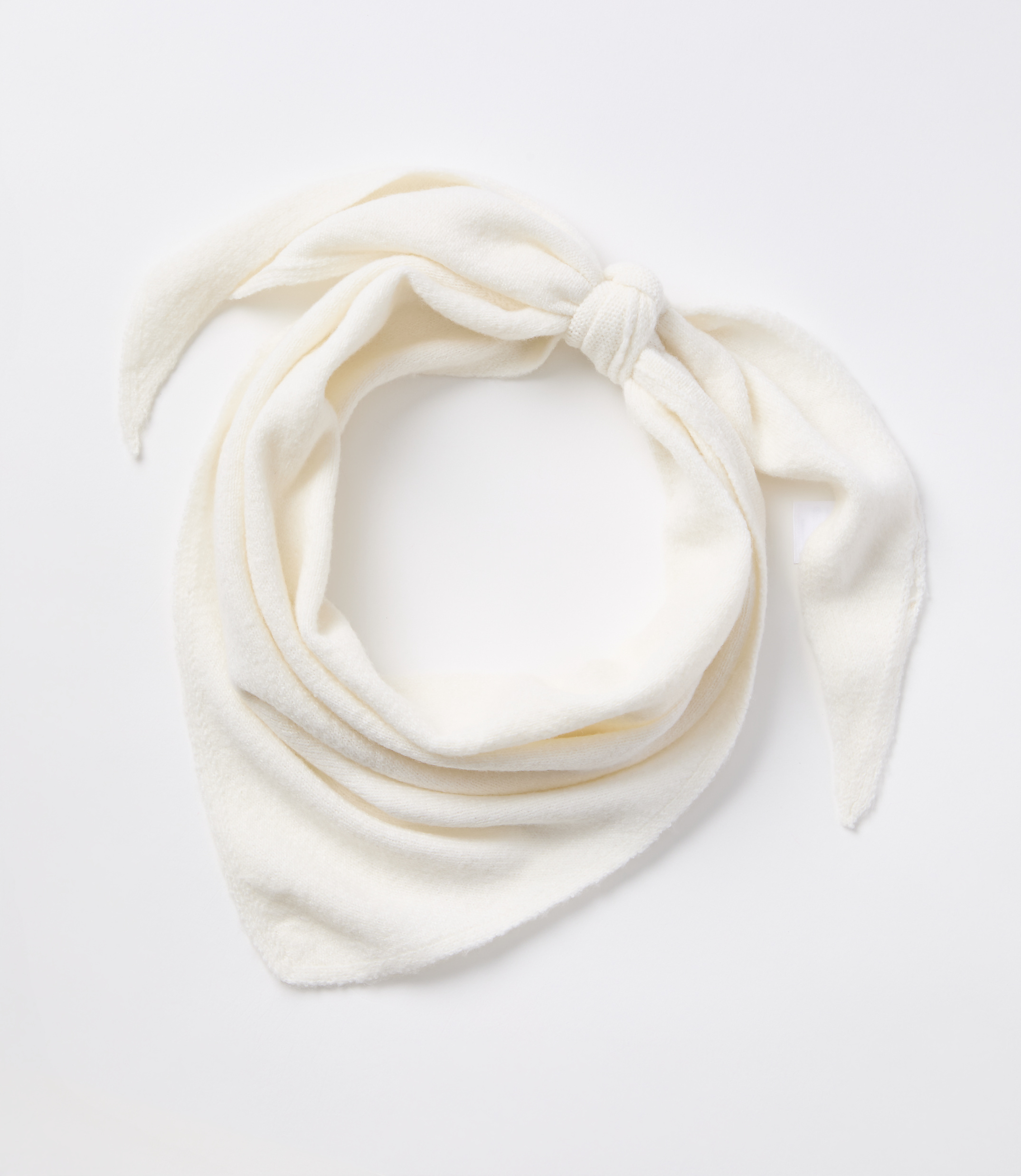 A cream-colored bandana is tied in a knot in the foreground against a plain white background.