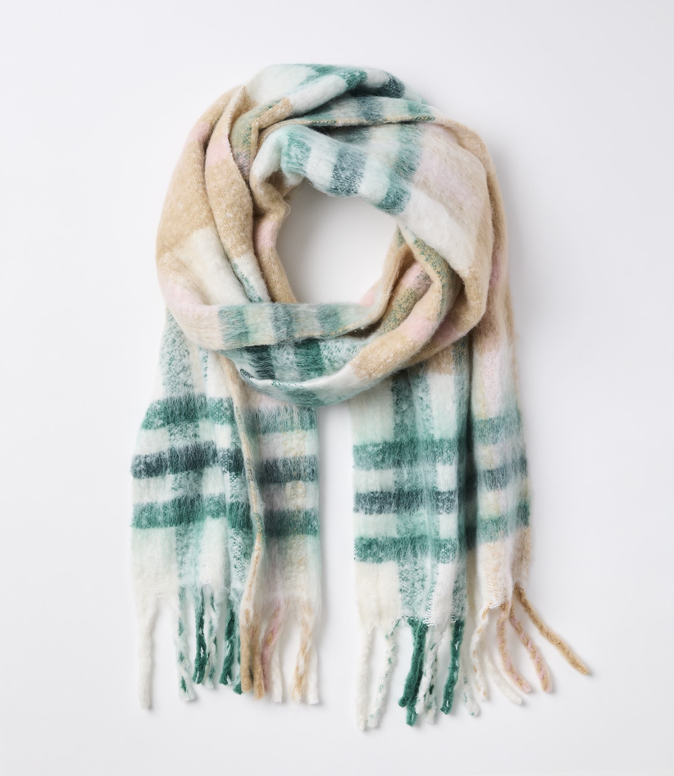 A soft, plaid scarf with fringe in pastel colors is laid out against a plain white background.