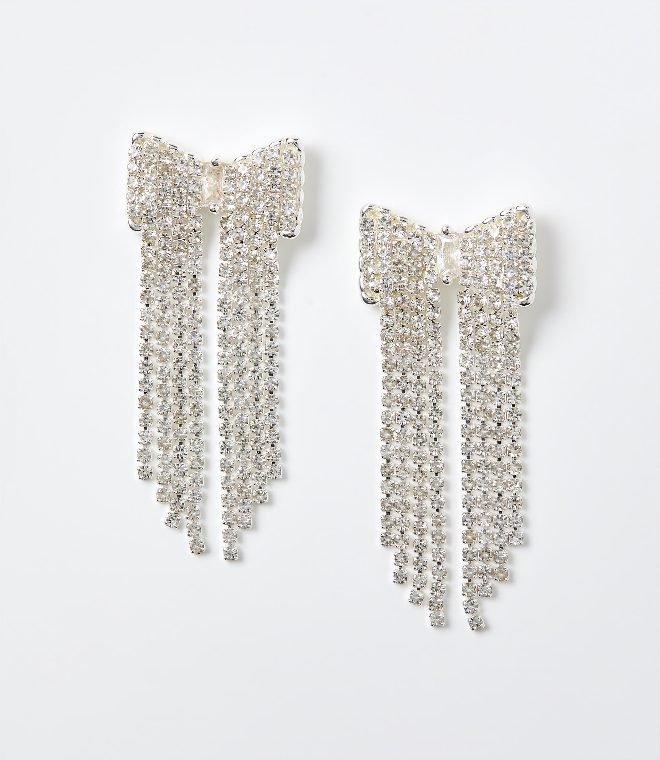 Two sparkling crystal bow earrings with long dangling fringes are set against a plain white background.