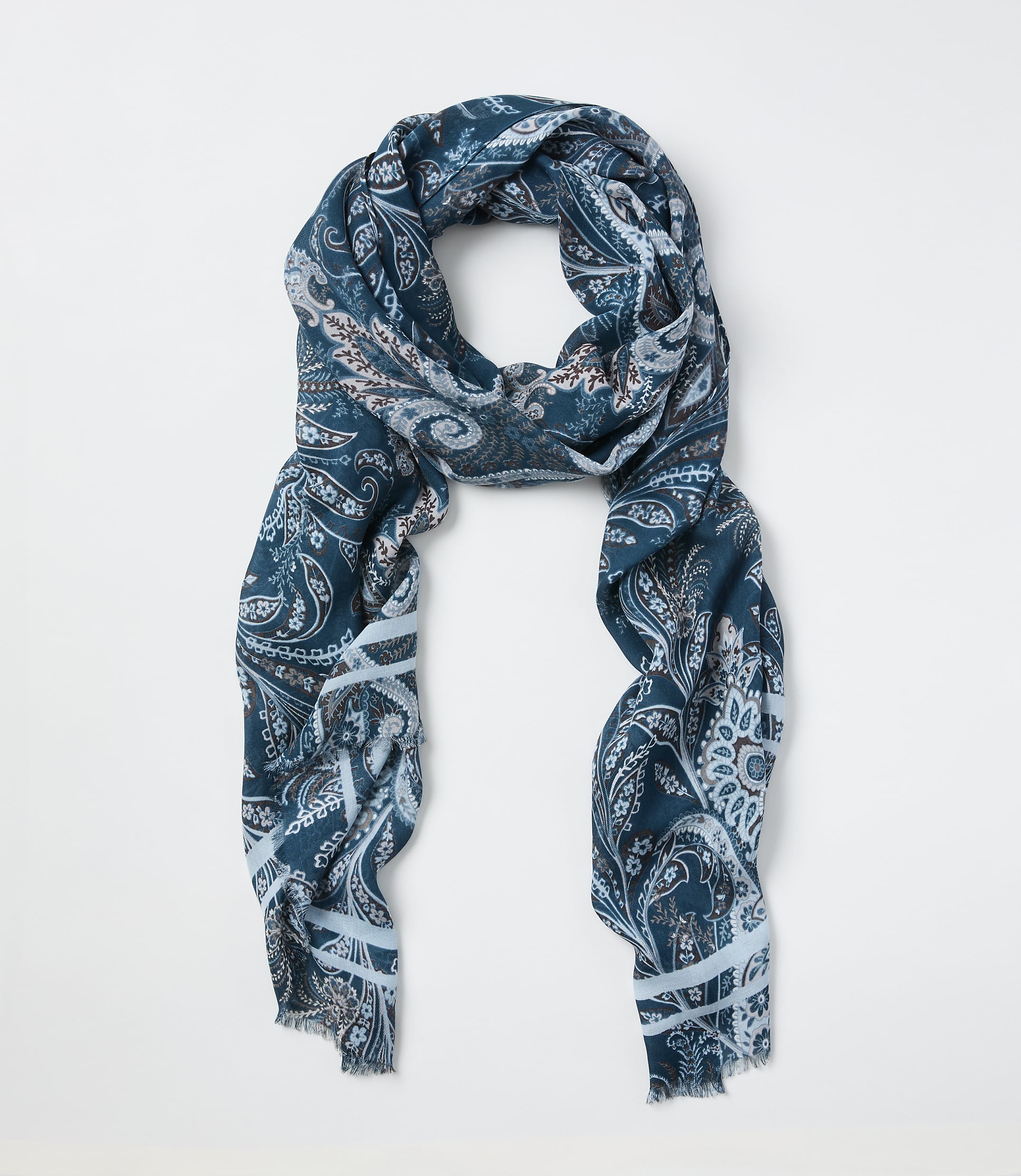 A teal paisley-patterned scarf is laid out against a plain white background.