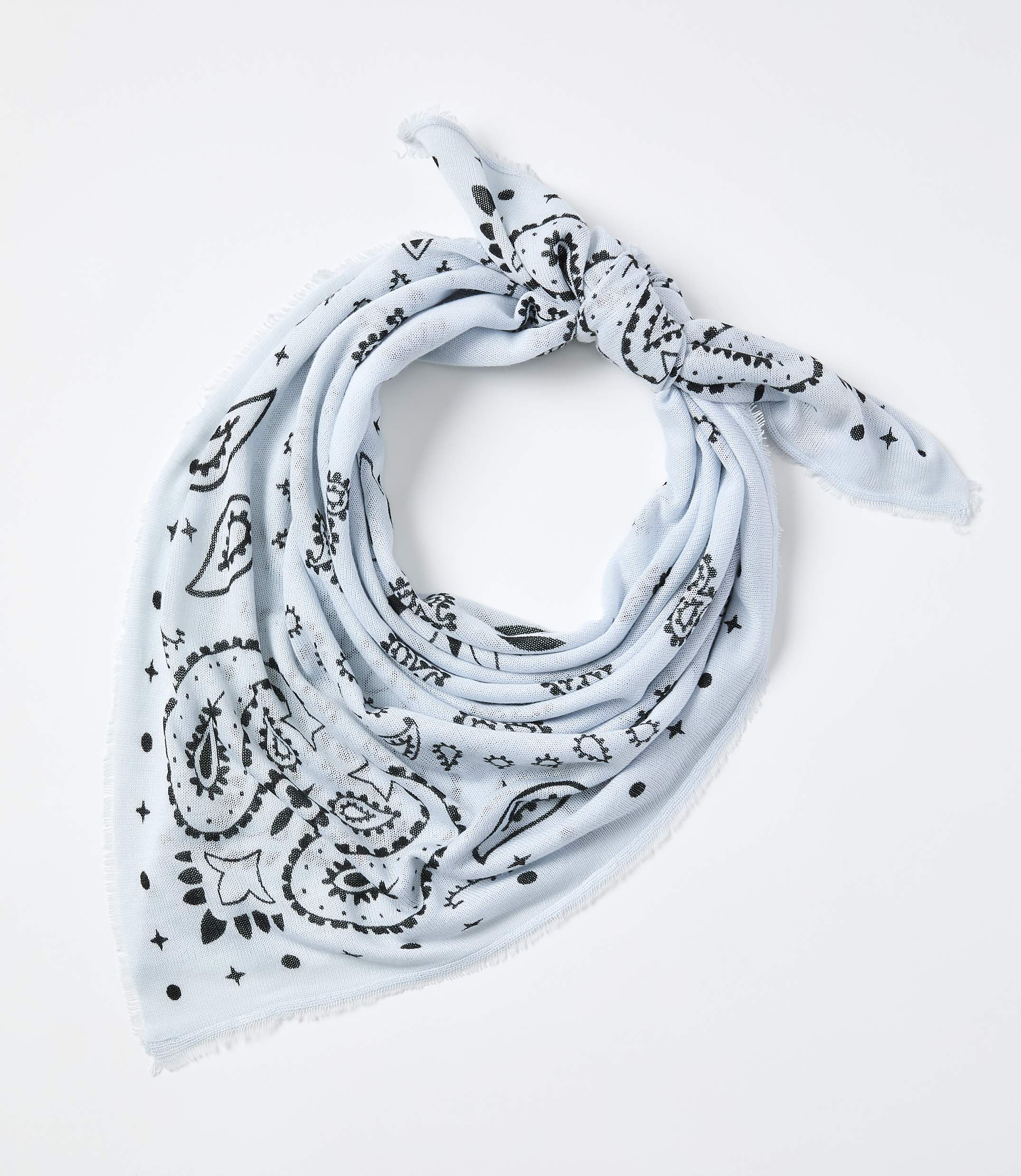A light blue paisley-patterned bandana is tied in a knot against a plain white background.