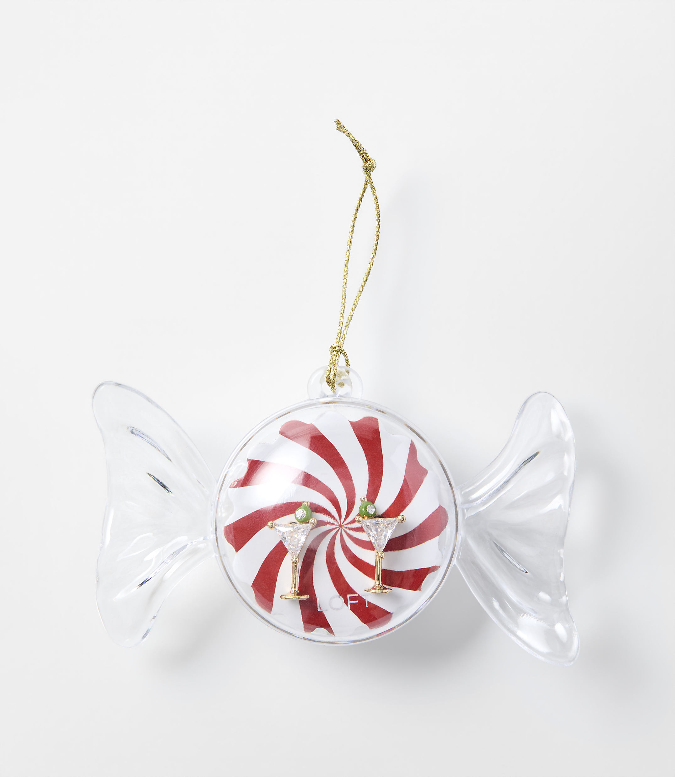 A candy-shaped Christmas ornament with red and white swirls and two martini glasses sits against a plain white background.