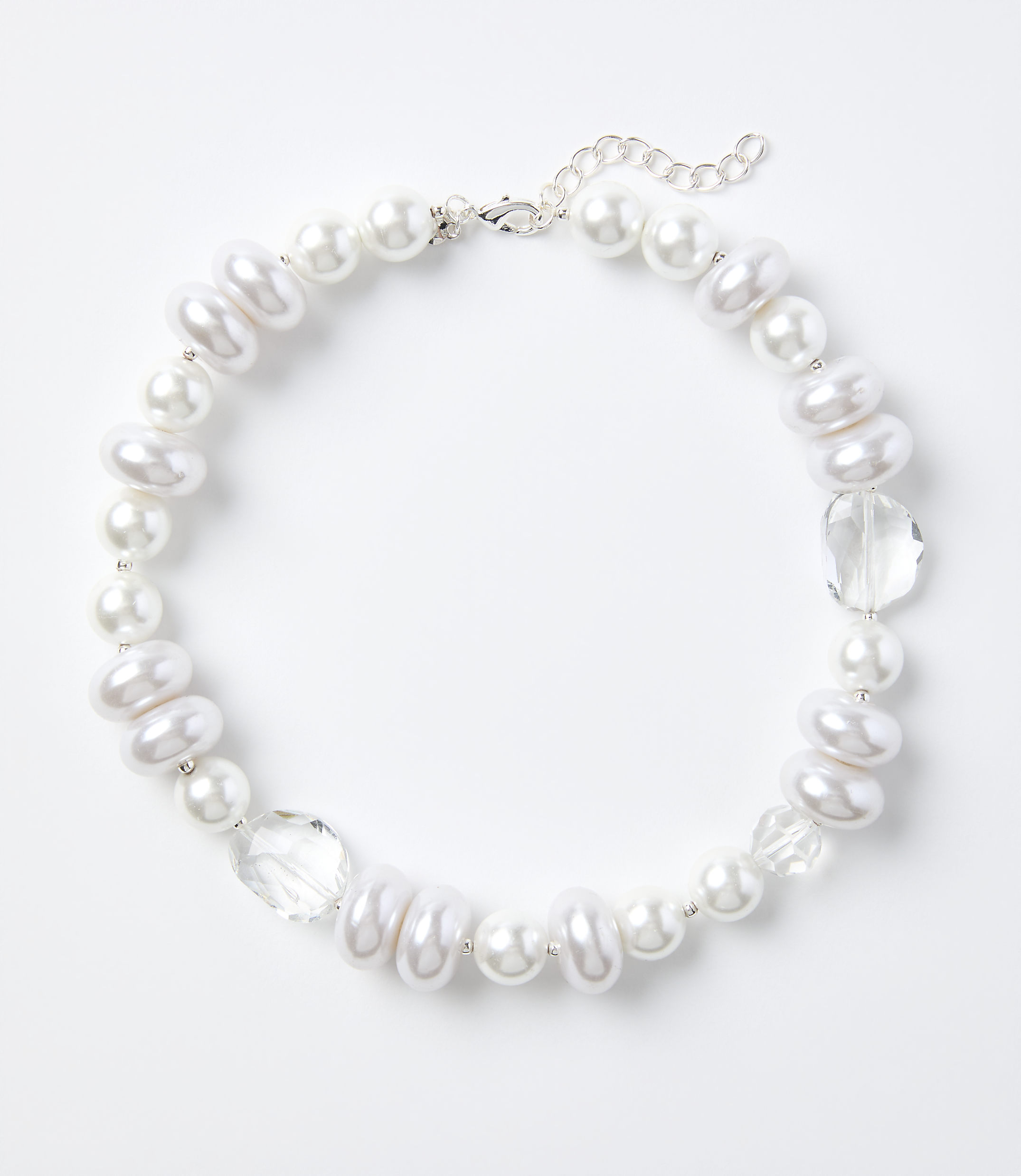 A white pearl and crystal necklace rests on a plain white background.