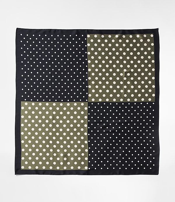 A black and olive green polka dot pocket square with a black border lies flat against a white background.