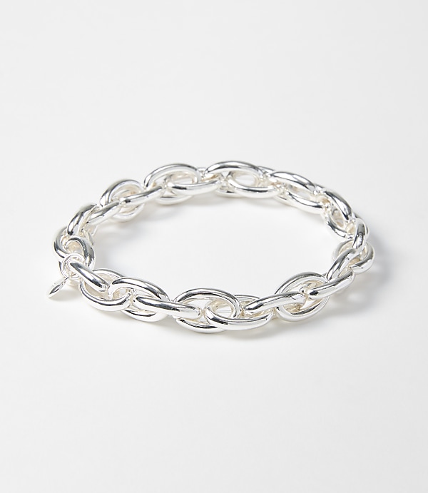 A silver chain bracelet with oval links rests on a plain white background.