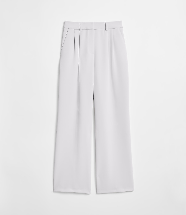 Light gray wide-leg trousers with pleats are laid flat against a plain white background.