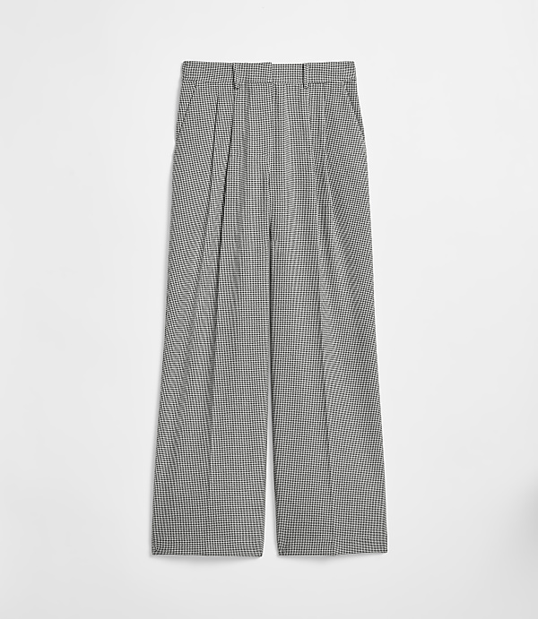 Pleated, wide-leg trousers with a subtle checkered pattern are laid flat against a plain white background.