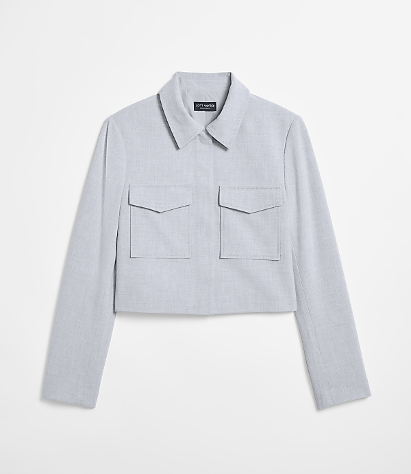 A light blue cropped jacket with two chest pockets is displayed against a plain white background.