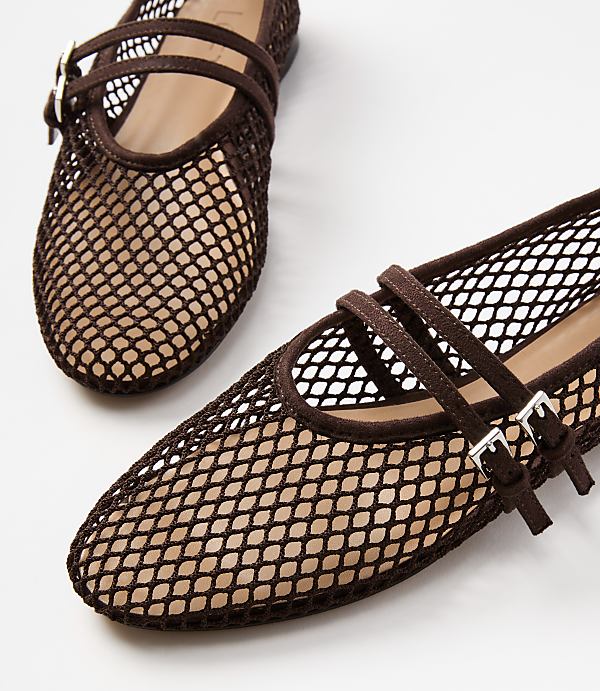 A pair of brown mesh ballet flats with double ankle straps are in the foreground against a plain white background.