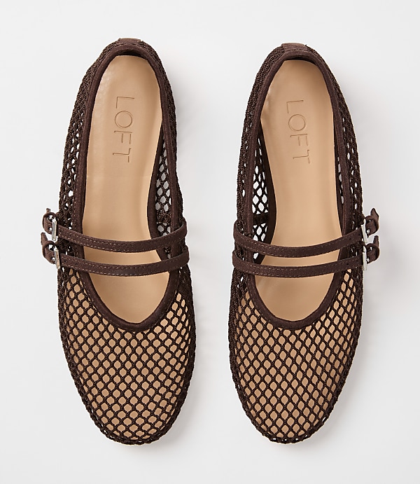 A pair of brown mesh ballet flats with double buckle straps rests on a plain white background.