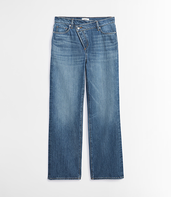A pair of blue denim jeans with an asymmetrical waistband lies flat against a plain white background.