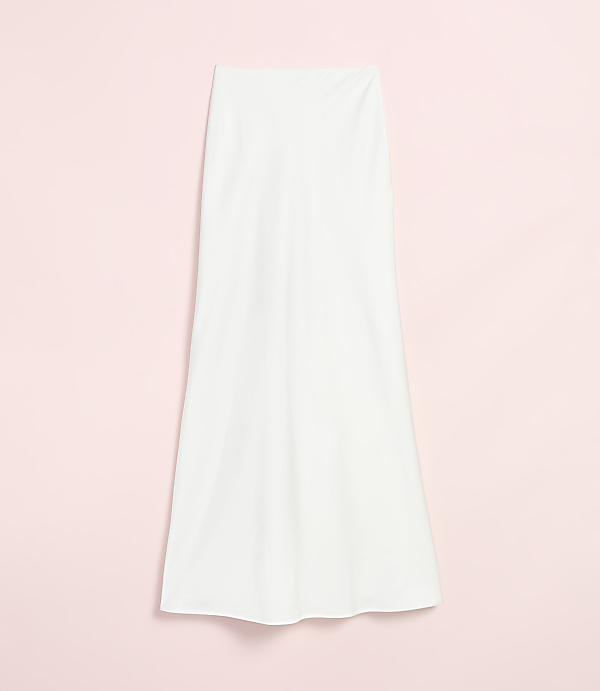 A white, flowing skirt hangs against a soft pink background.