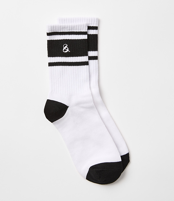 A pair of white crew socks with black stripes and an ampersand logo are laid out against a plain white background.