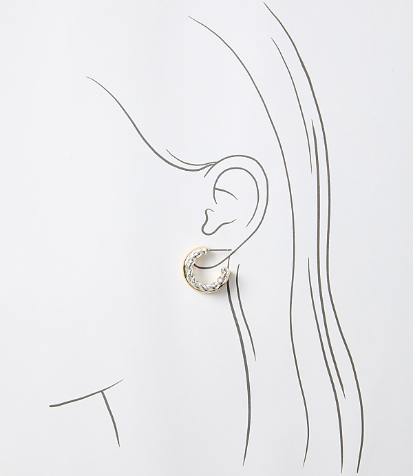 A detailed sketch of a woman's ear showcases a delicate, circular earring in the foreground against a minimalist, white background.