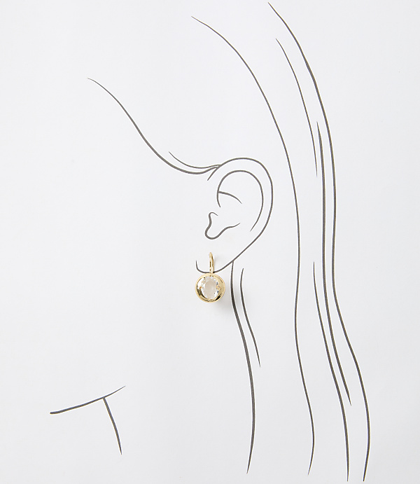 A gold earring with a clear stone hangs from a sketched ear against a plain white background.