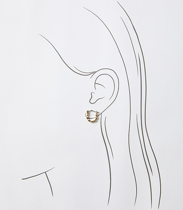 A delicate gold hoop earring adorns a sketched ear against a plain white background.