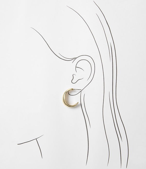 A simple gold hoop earring adorns a sketched ear and flowing hair against a plain white background.