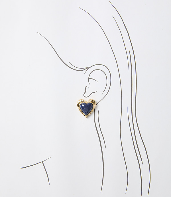 A gold heart-shaped earring with a blue stone is worn on a sketched ear against a white background.