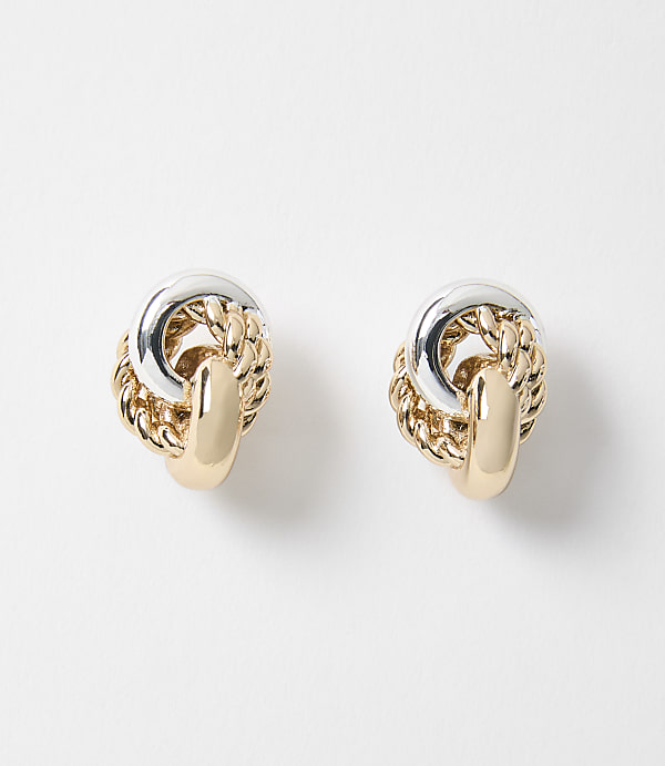 Two intertwined gold and silver knot earrings rest on a plain white background.