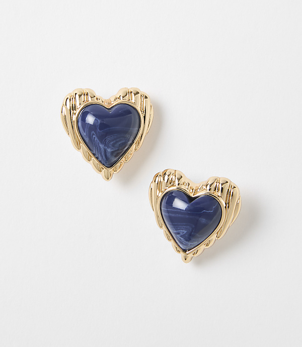 Two gold heart-shaped earrings with marbled blue centers rest on a plain white background.
